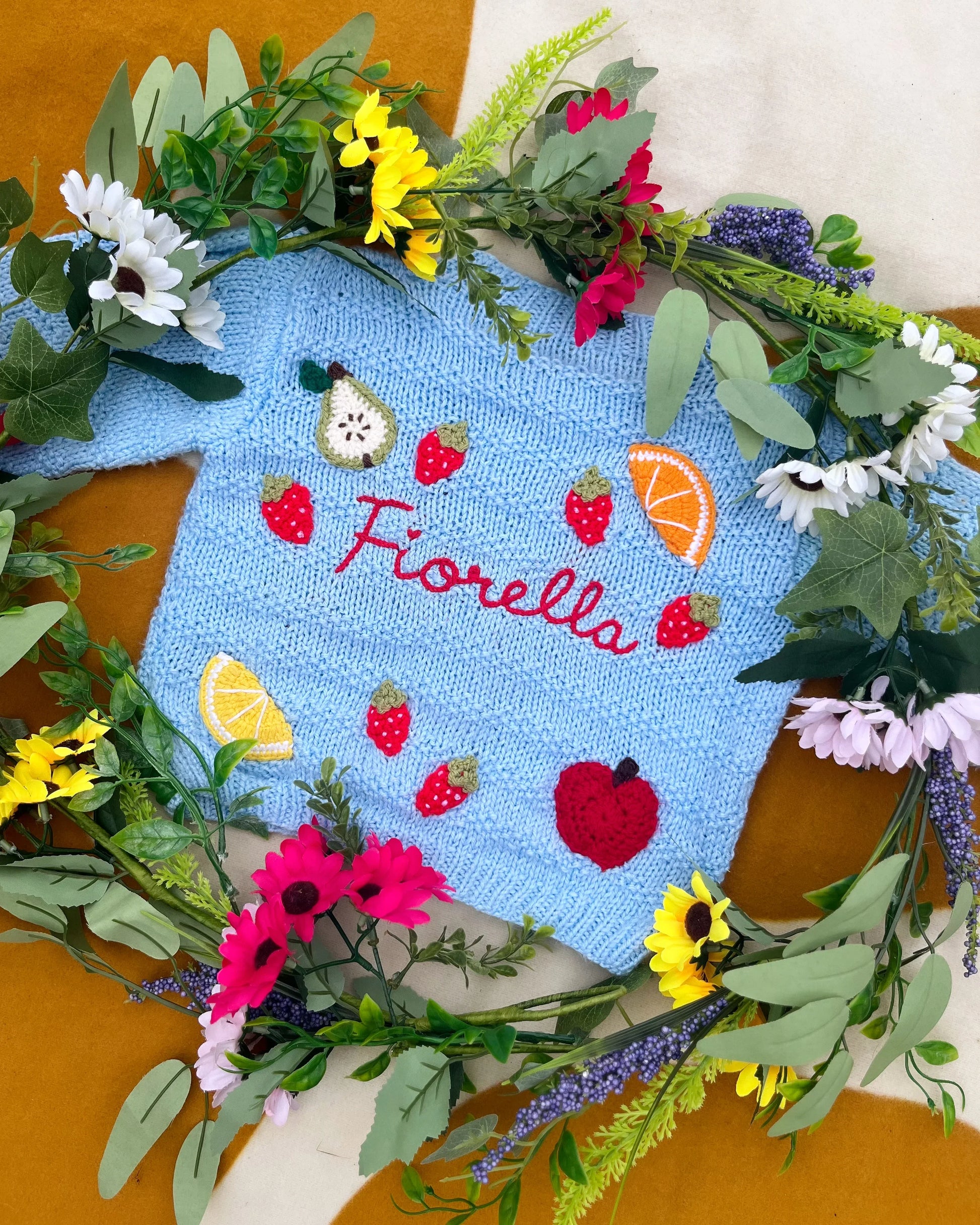 Little Flower Knits blue fruit pattern cardigan for toddlers with embroidered fruit designs and buttons