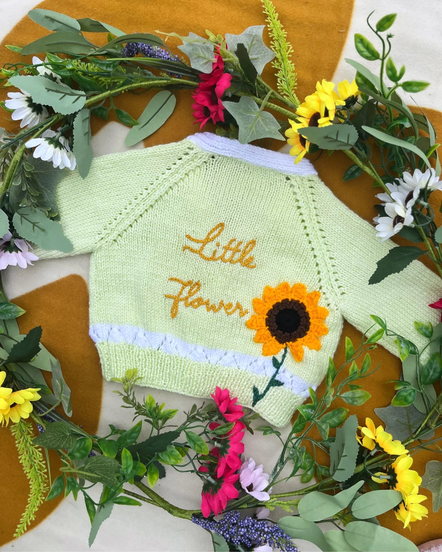 Personalised sunflower cardigan for kids by Little Flower Knits in pastel green with sunflower design and embroidered text