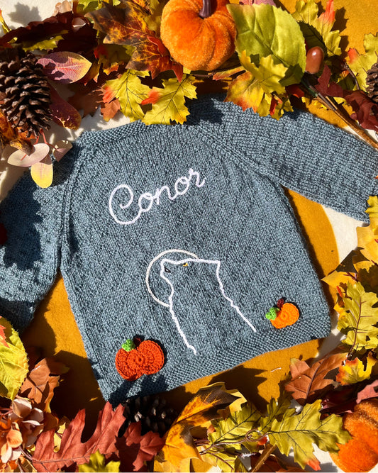 Hand knitted baby cardigan with embroidered wolf outline and name Conor in blue grey ideal unique boy wolf gift ideas