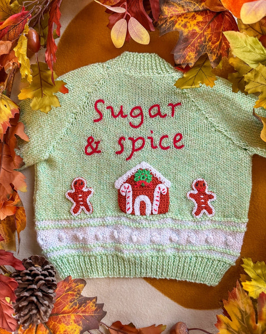 Handmade baby cardigan UK with 'Sugar & Spice' embroidery and gingerbread house design