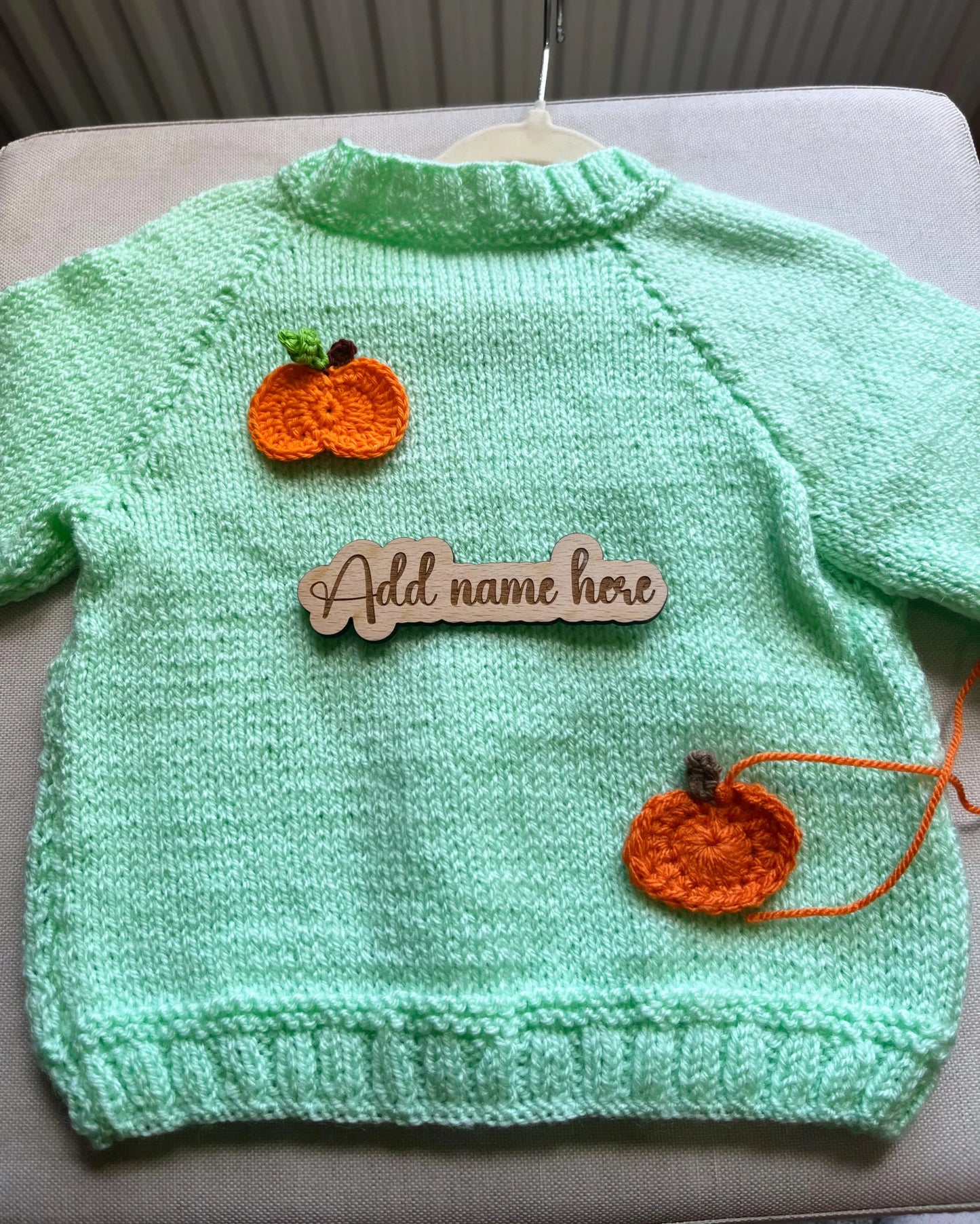 Mint green knitted toddler jumper with two orange pumpkin appliques and wooden name sign custom pumpkin outfit for toddlers