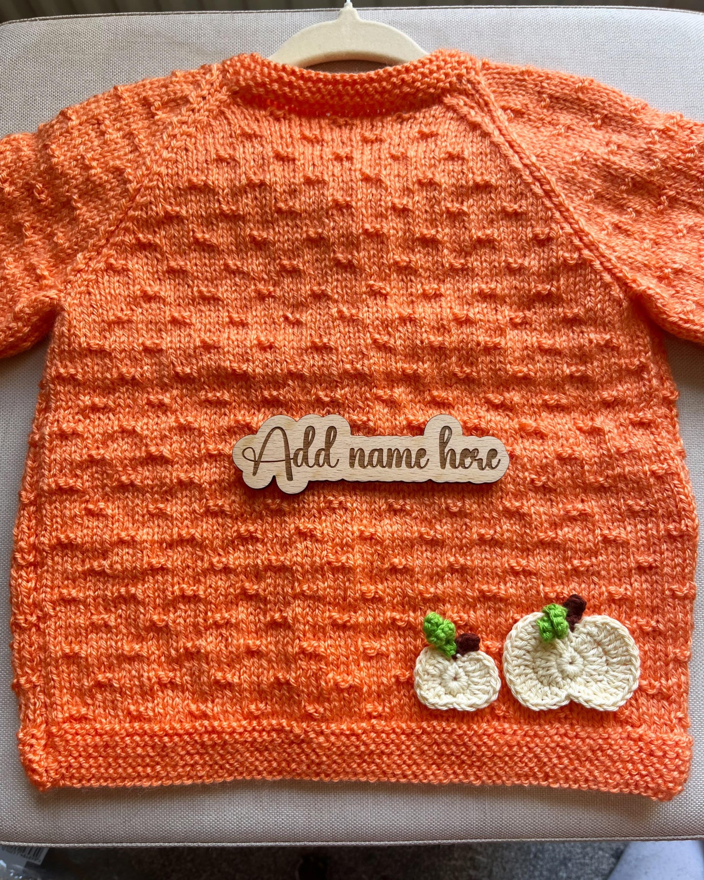 Little Flower Knits orange handknit toddler sweater with two crochet pumpkins and name tag custom pumpkin outfit for toddlers