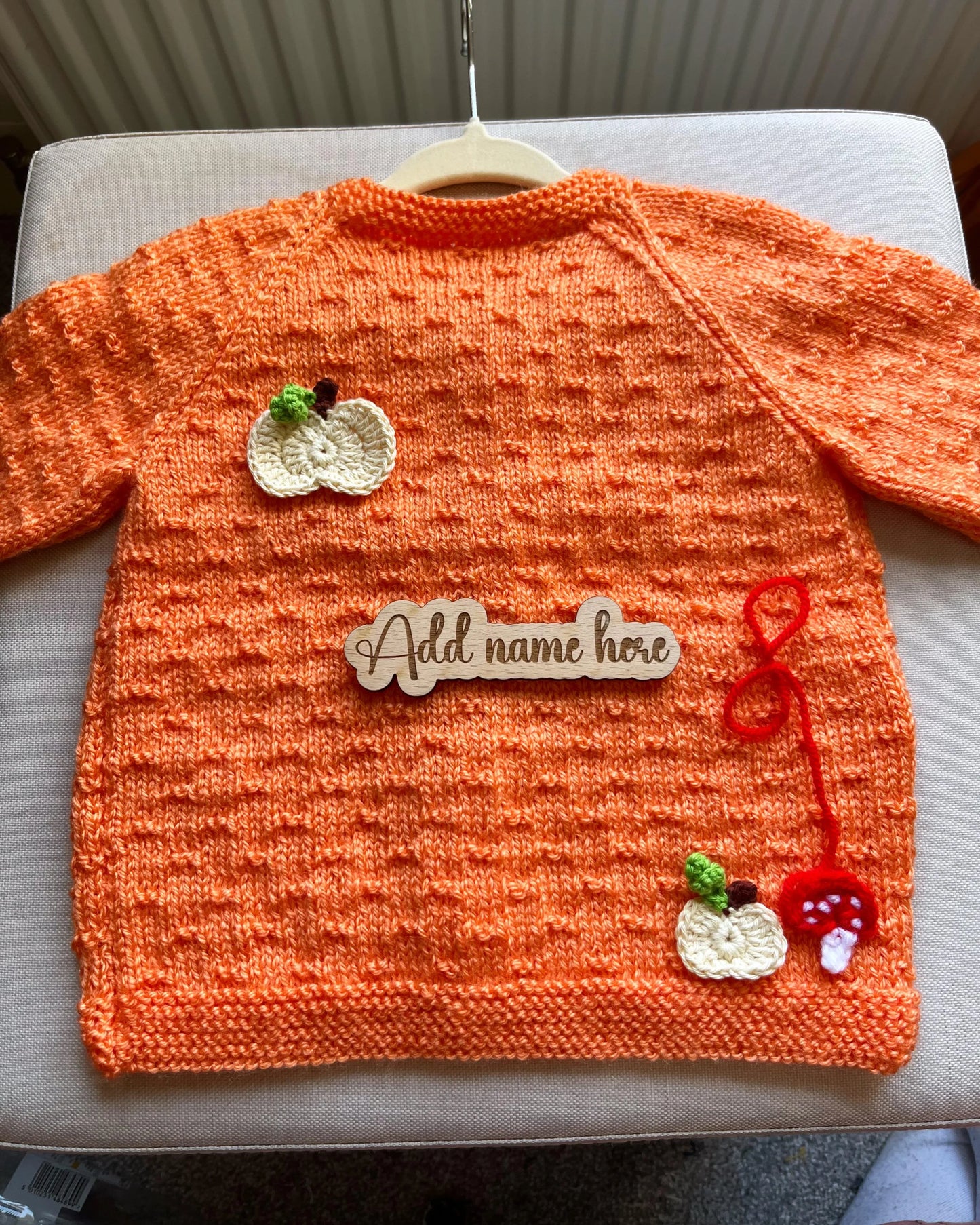 Little Flower Knits orange handknit cardigan with appliques and wooden name sign custom pumpkin outfit for toddlers