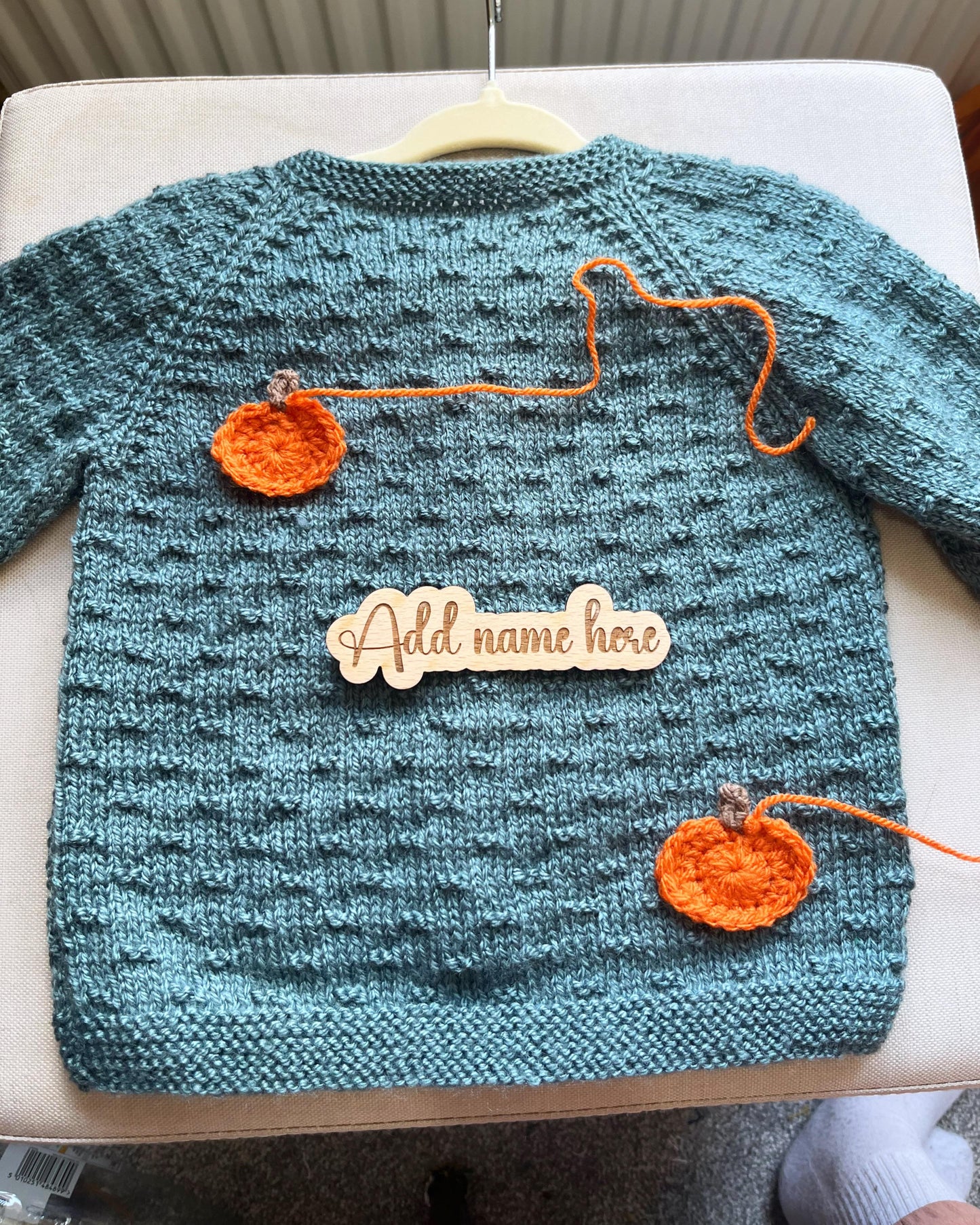 Teal handknit toddler sweater with two crocheted pumpkins and wooden name plaque custom pumpkin outfit for toddlers