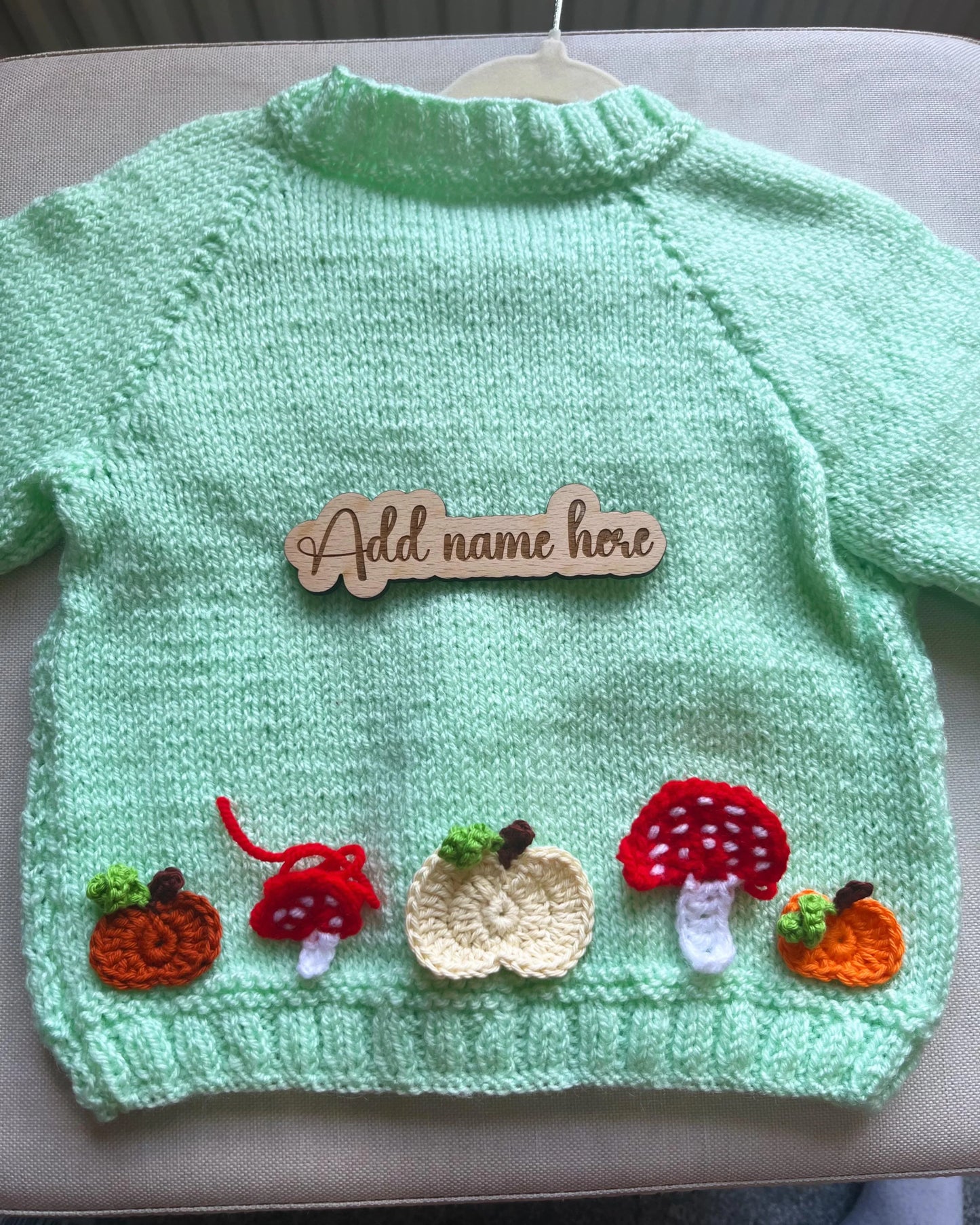 Little Flower Knits hand-knitted pumpkin and toadstool costume mint green baby cardigan with applique pumpkins and red toadstools
