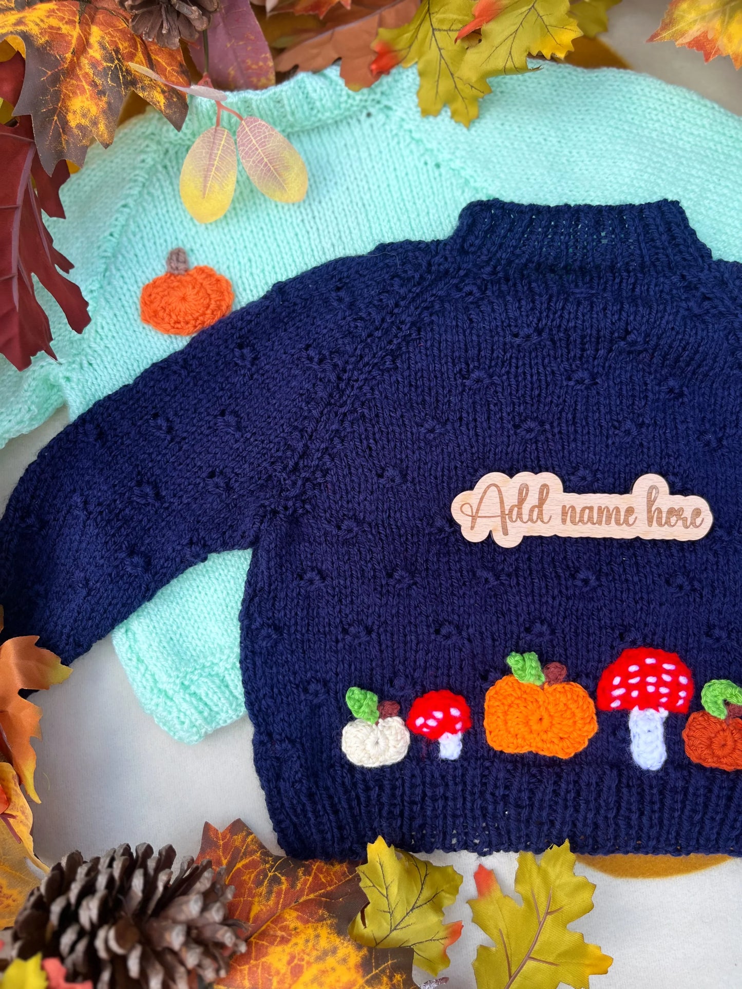 Little Flower Knits navy and mint children jumpers with hand-knitted pumpkin and toadstool costume appliques and wooden name tag