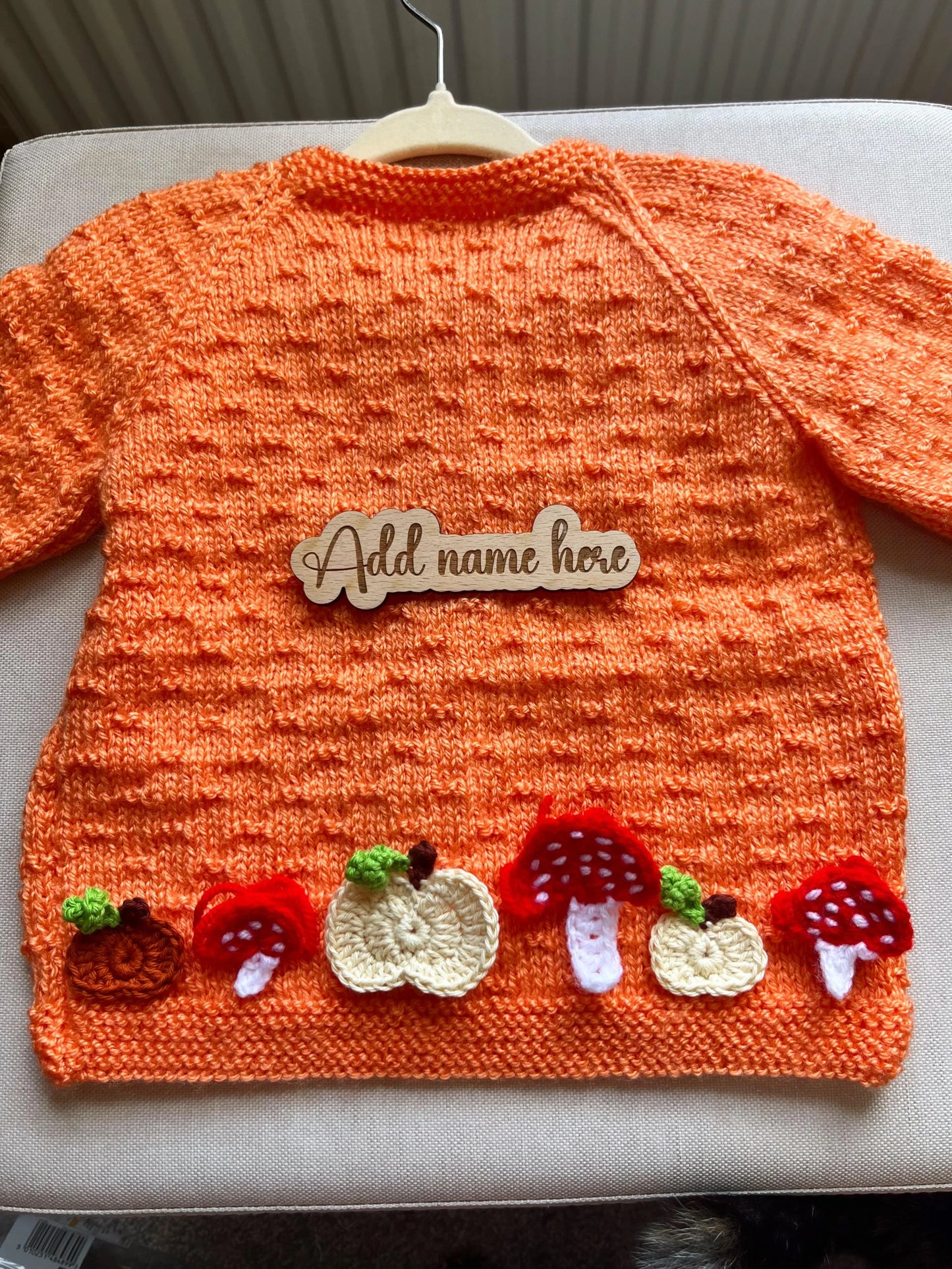 Orange baby sweater with pumpkin and toadstool appliques and wooden name tag hand-knitted pumpkin and toadstool costume