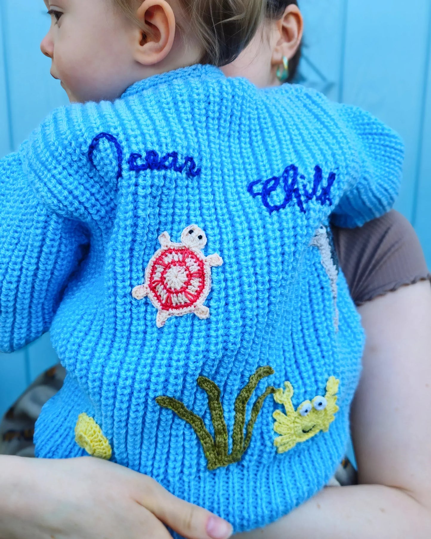Handmade ocean theme baby knitwear UK blue knitted cardigan with sea turtle and crab appliques