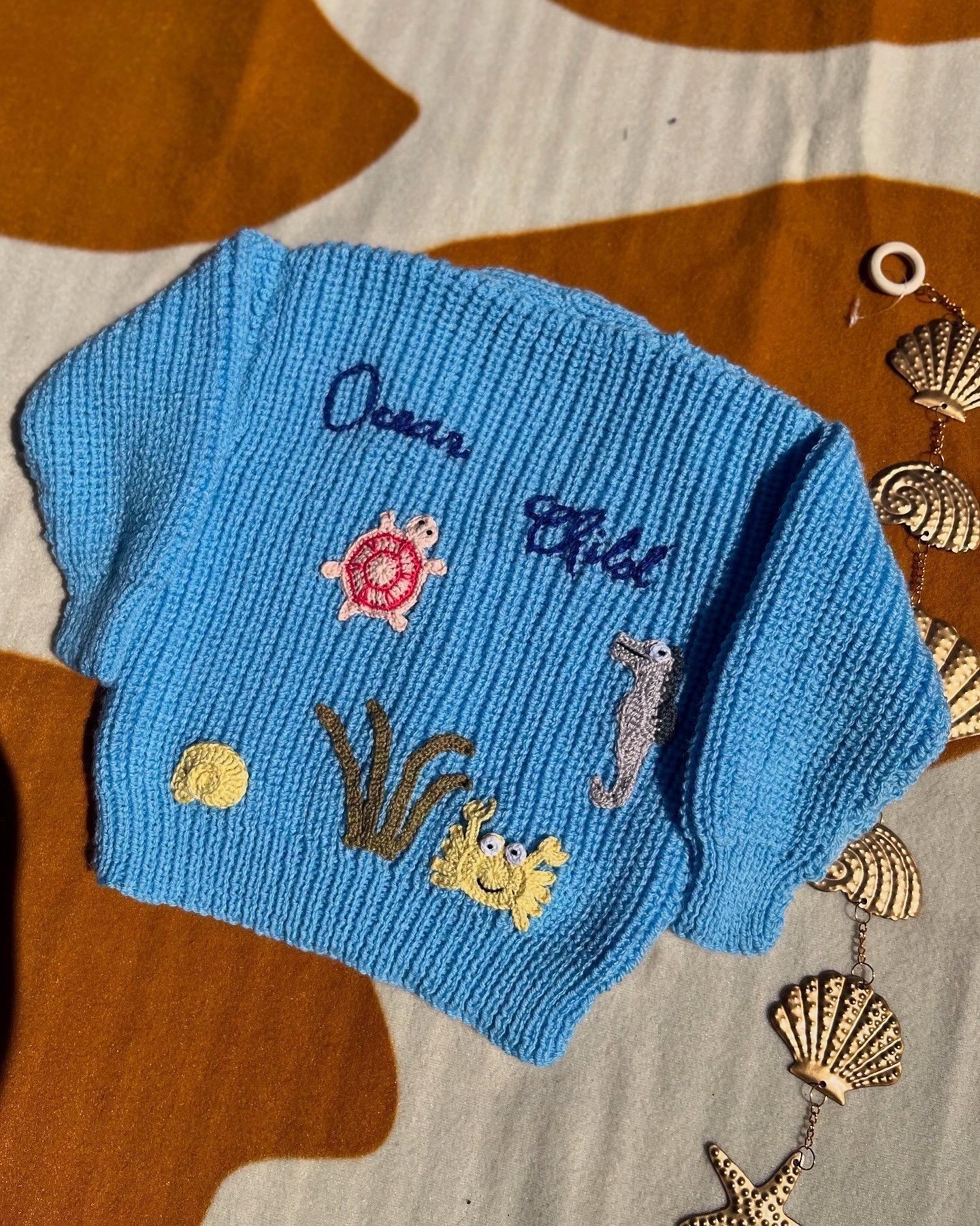 Handmade ocean theme baby knitwear UK blue knitted baby jumper with sea creatures and initials by Little Flower Knits