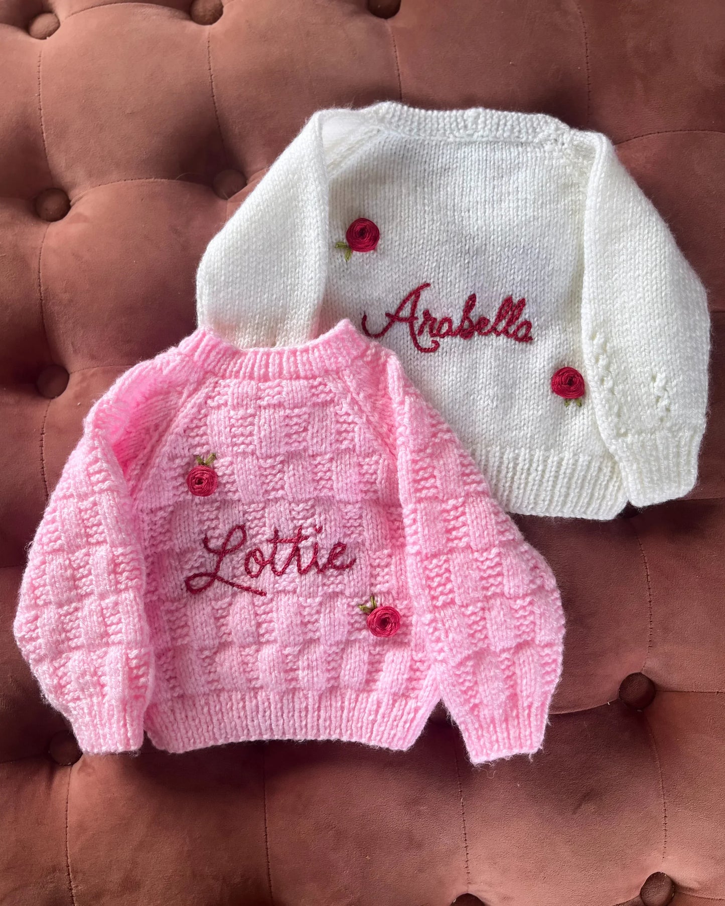 Personalised rose baby cardigan in white and pink with embroidered names and rose decorations by Little Flower Knits