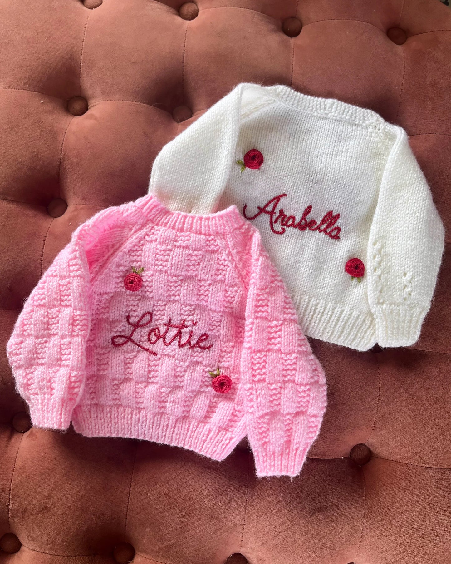 Personalised rose baby cardigan by Little Flower Knits in white and pink with embroidered names and rose buttons