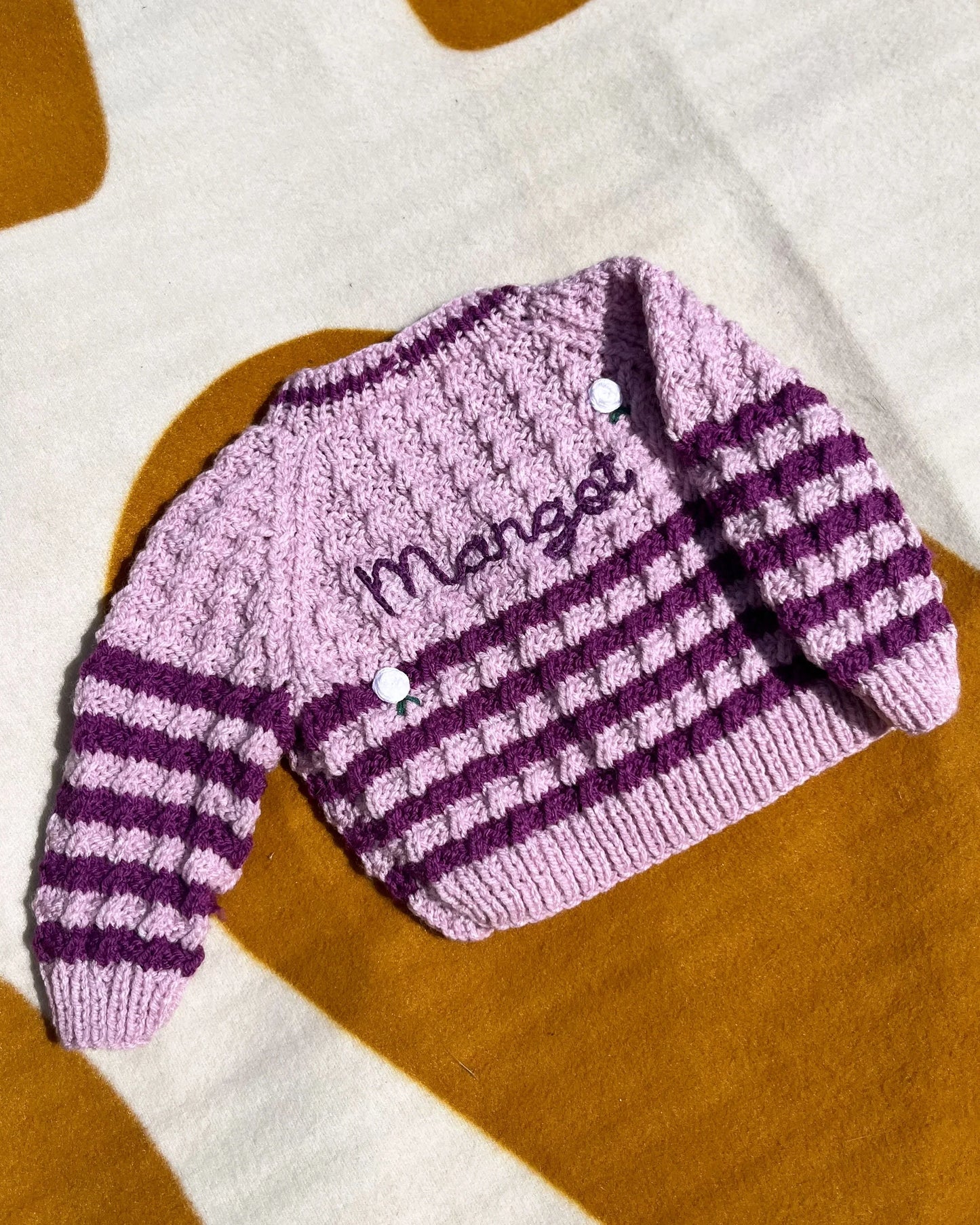 Personalised rose baby cardigan in pink and purple stripes with name embroidery and button details
