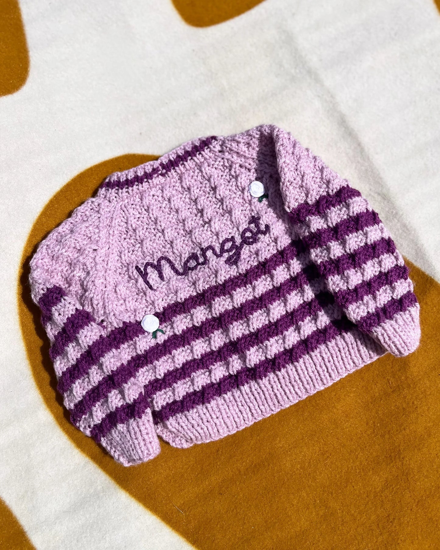 Personalised rose baby cardigan in pink and purple stripes with name embroidery by Little Flower Knits