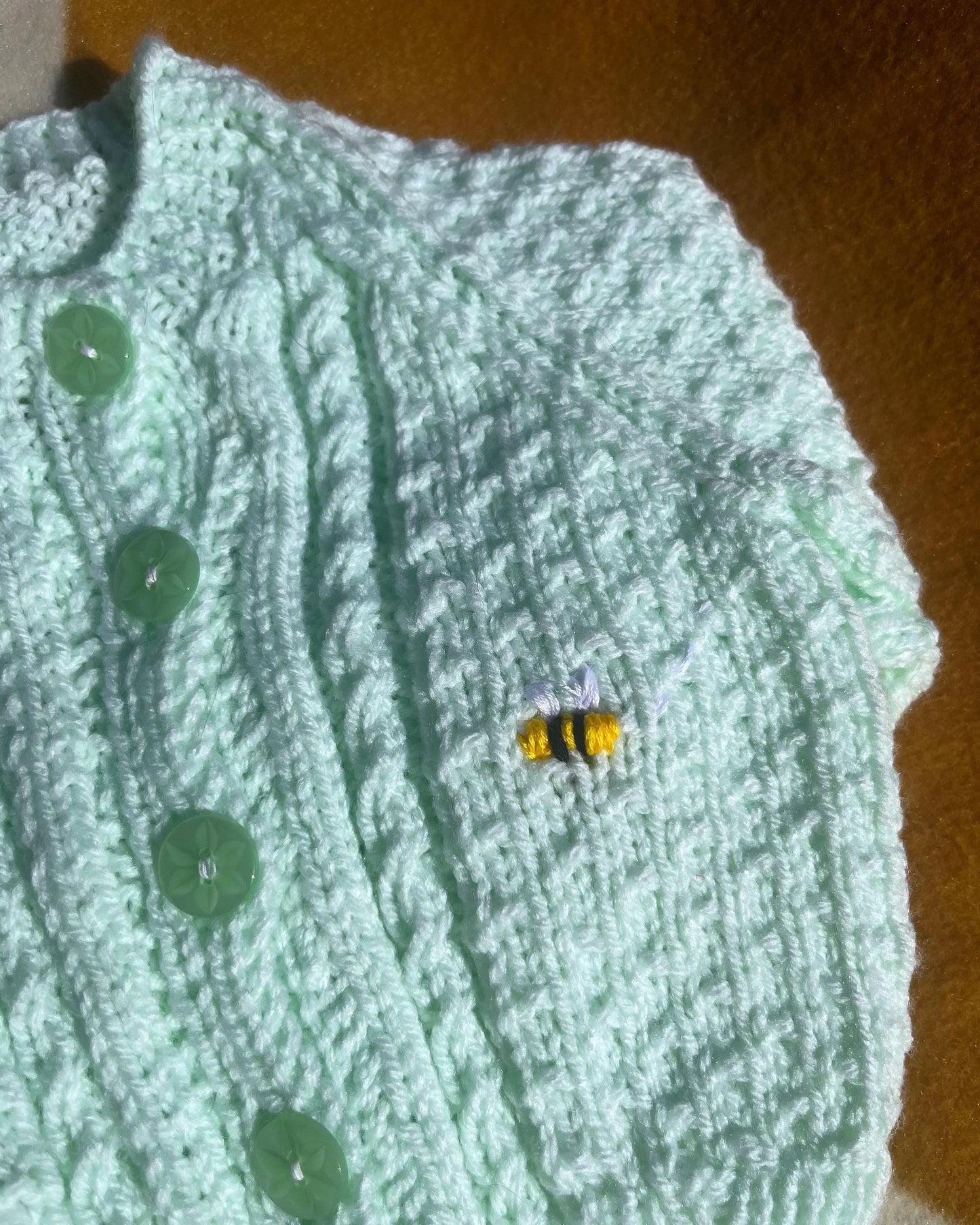 Green knitted lemon embroidery cardigan for babies featuring initial and button details by Little Flower Knits