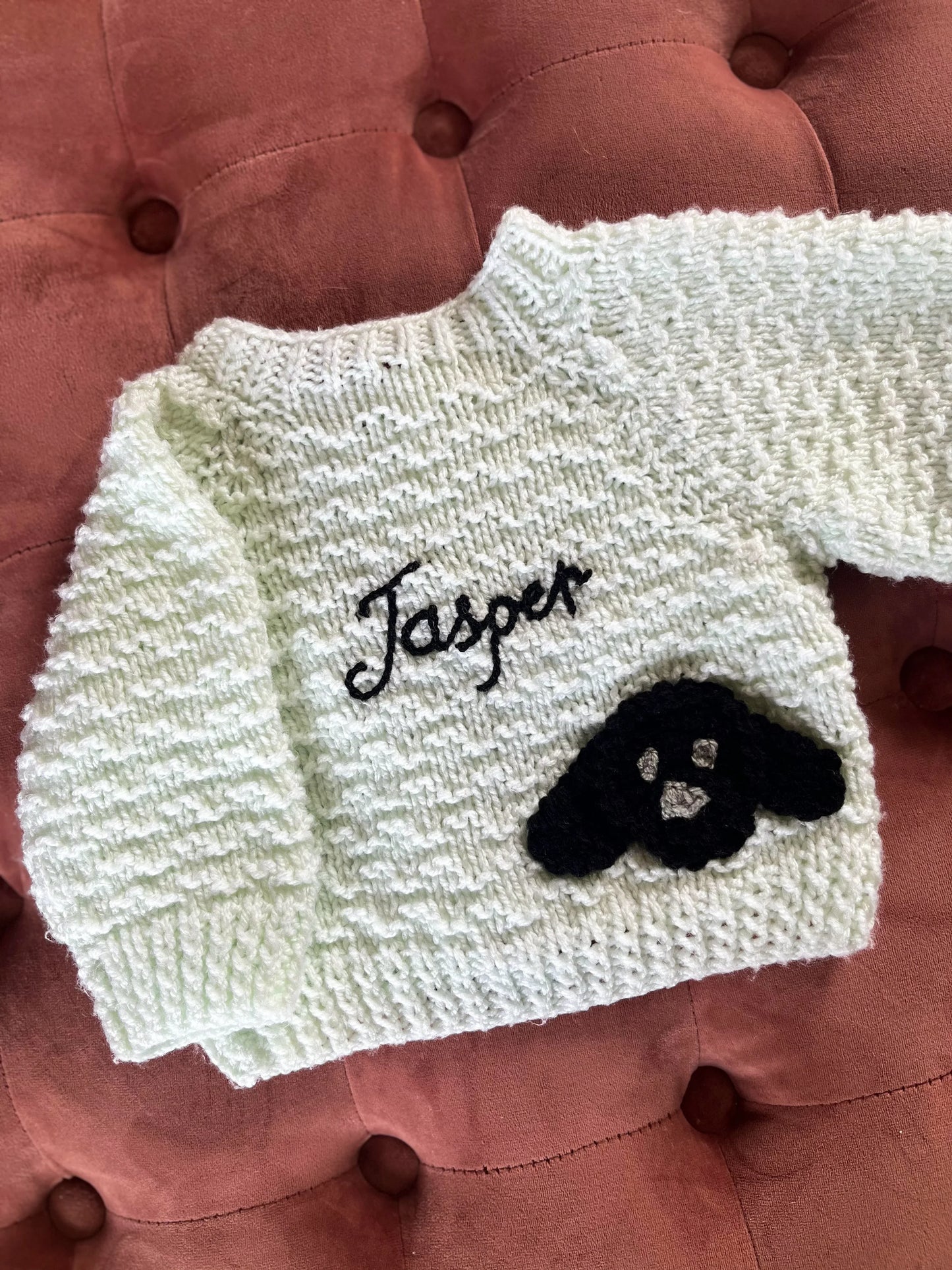 Little Flower Knits personalised baby cardigan UK with name Jasper and black dog design on white knitted fabric