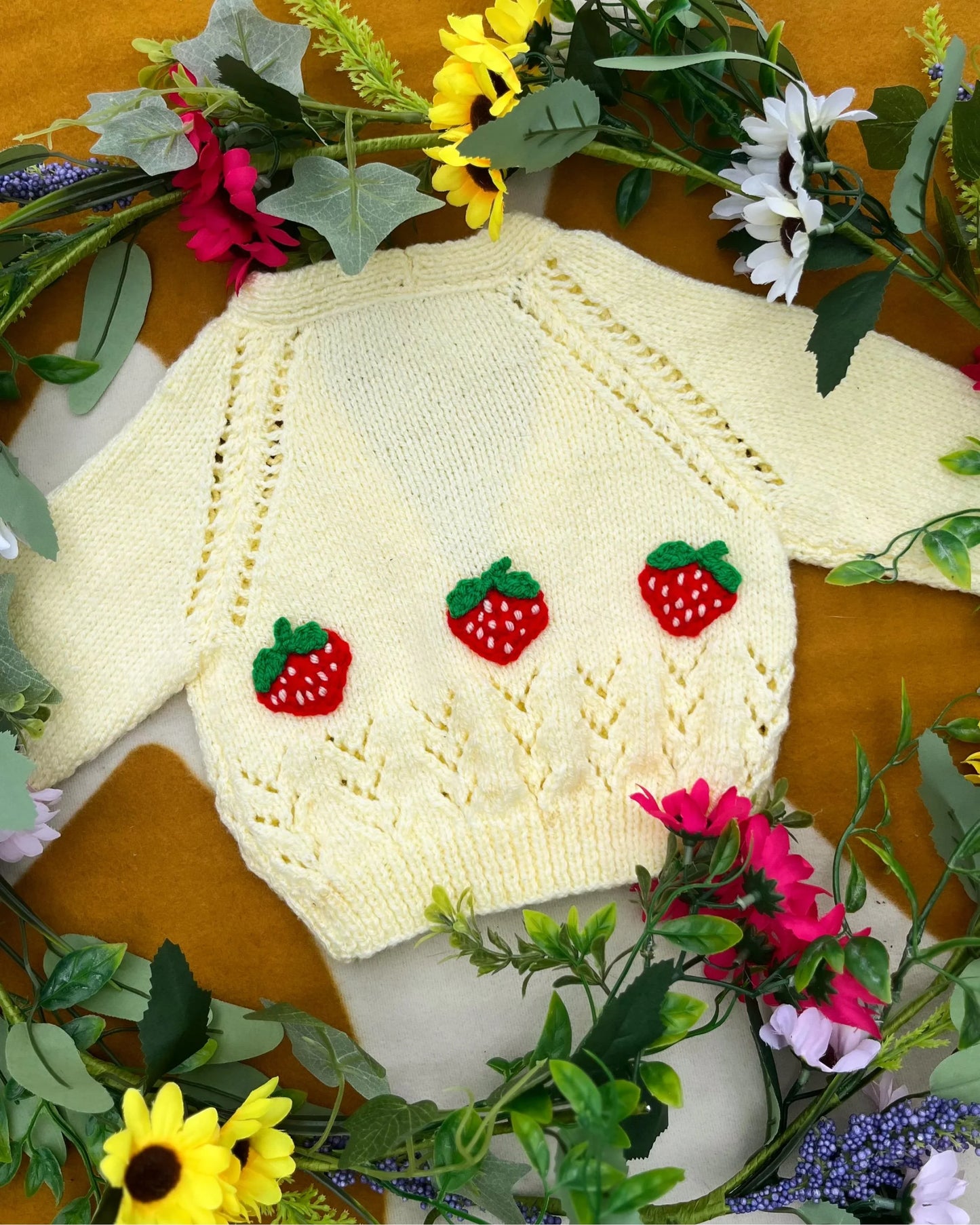 Little Flower Knits personalised baby strawberry cardigan in cream with red strawberry add ons and buttons