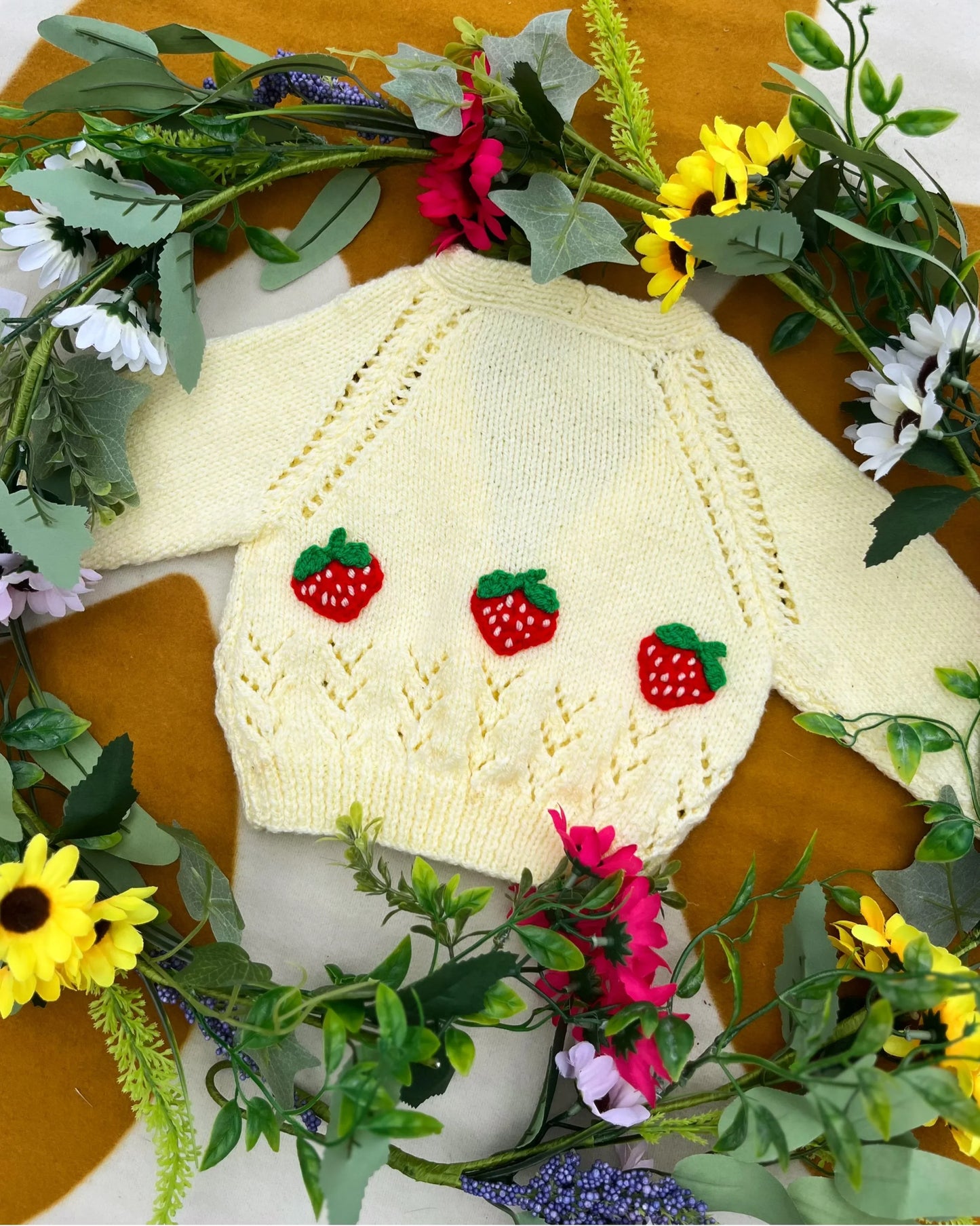 Personalised baby strawberry cardigan by Little Flower Knits cream knit sweater with three red strawberry appliques surrounded by flowers