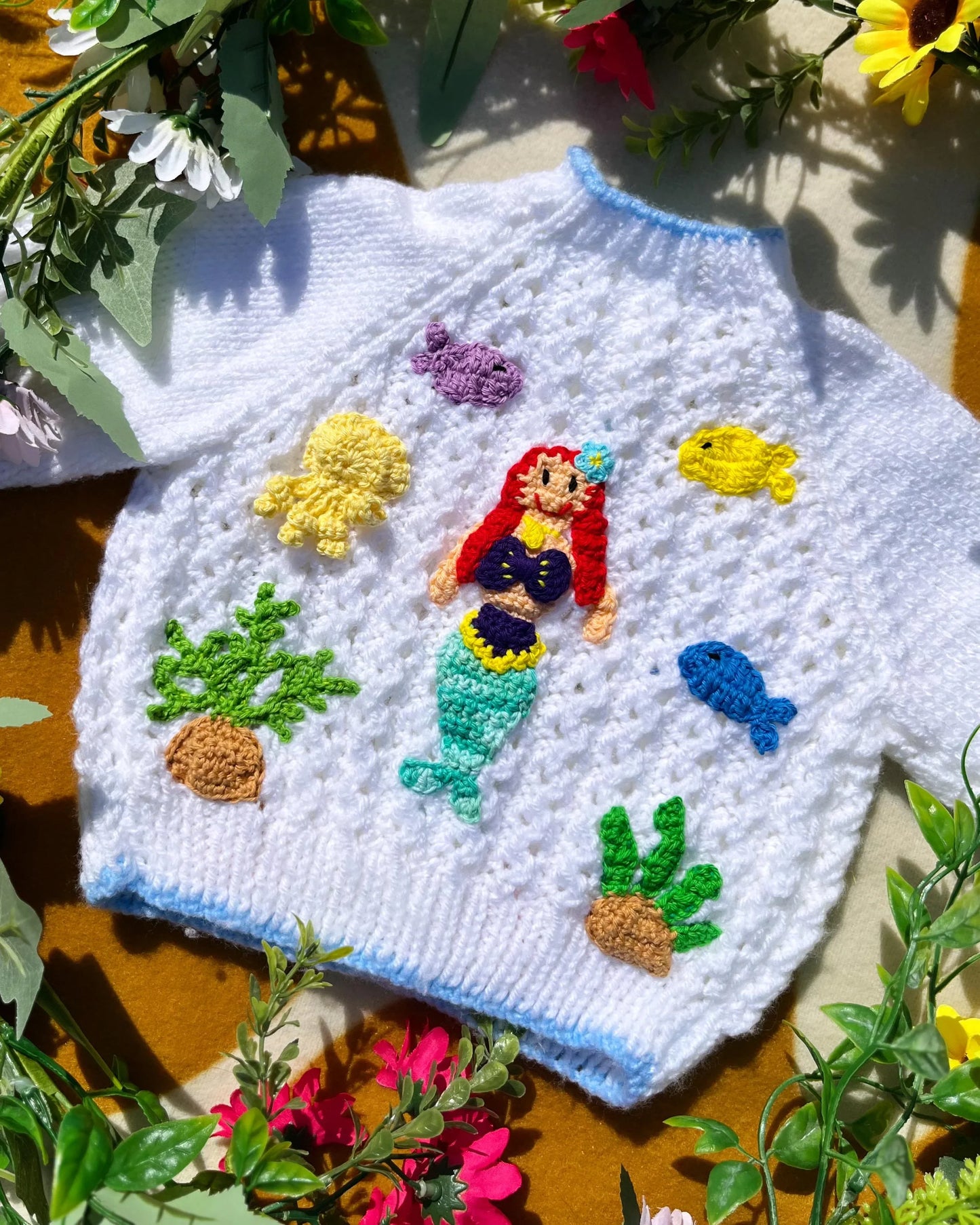 White knitted personalised mermaid cardigan featuring colourful sea creature appliques by Little Flower Knits