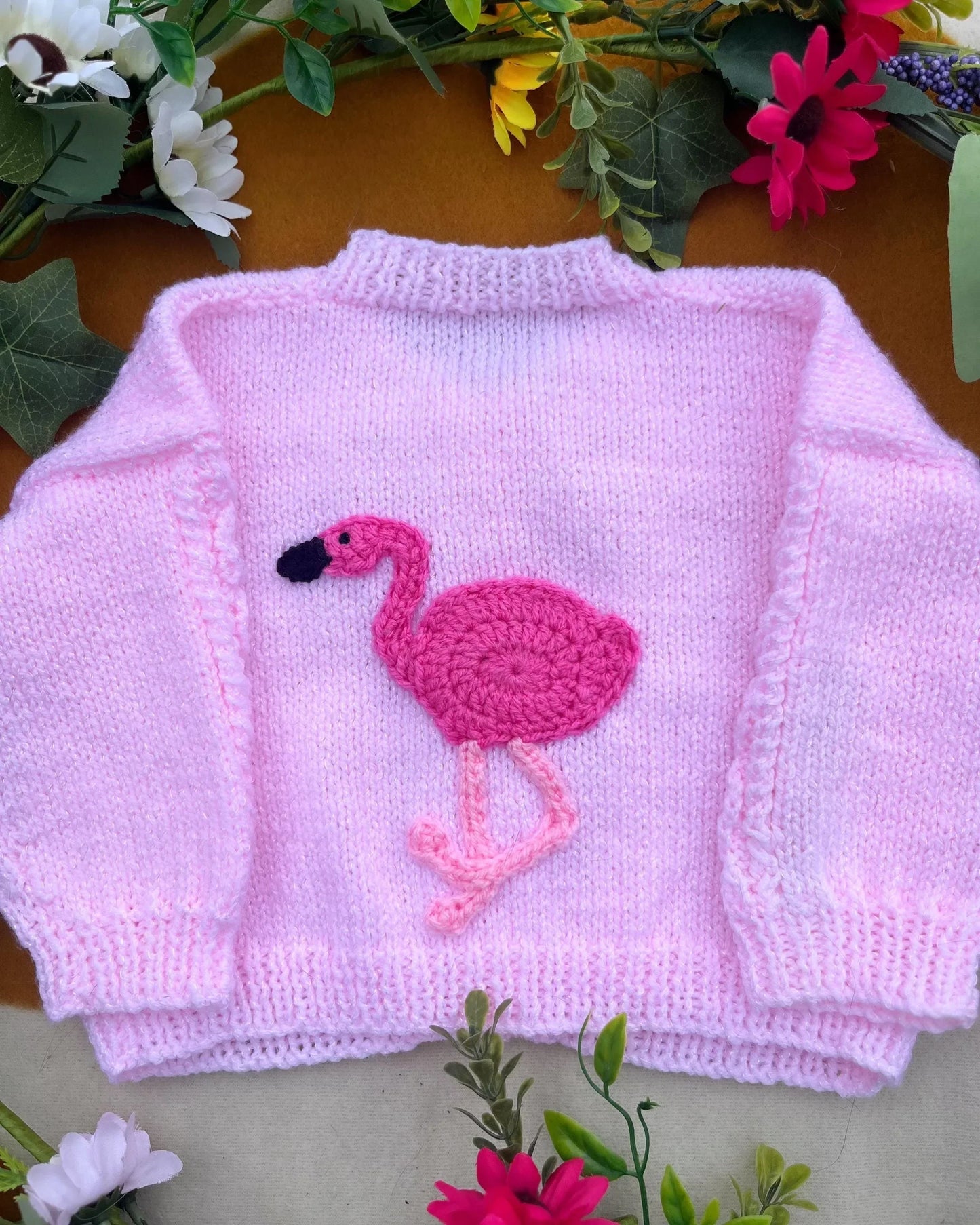 Little Flower Knits sustainable baby gift flamingo cardigan in soft pink with crochet flamingo design