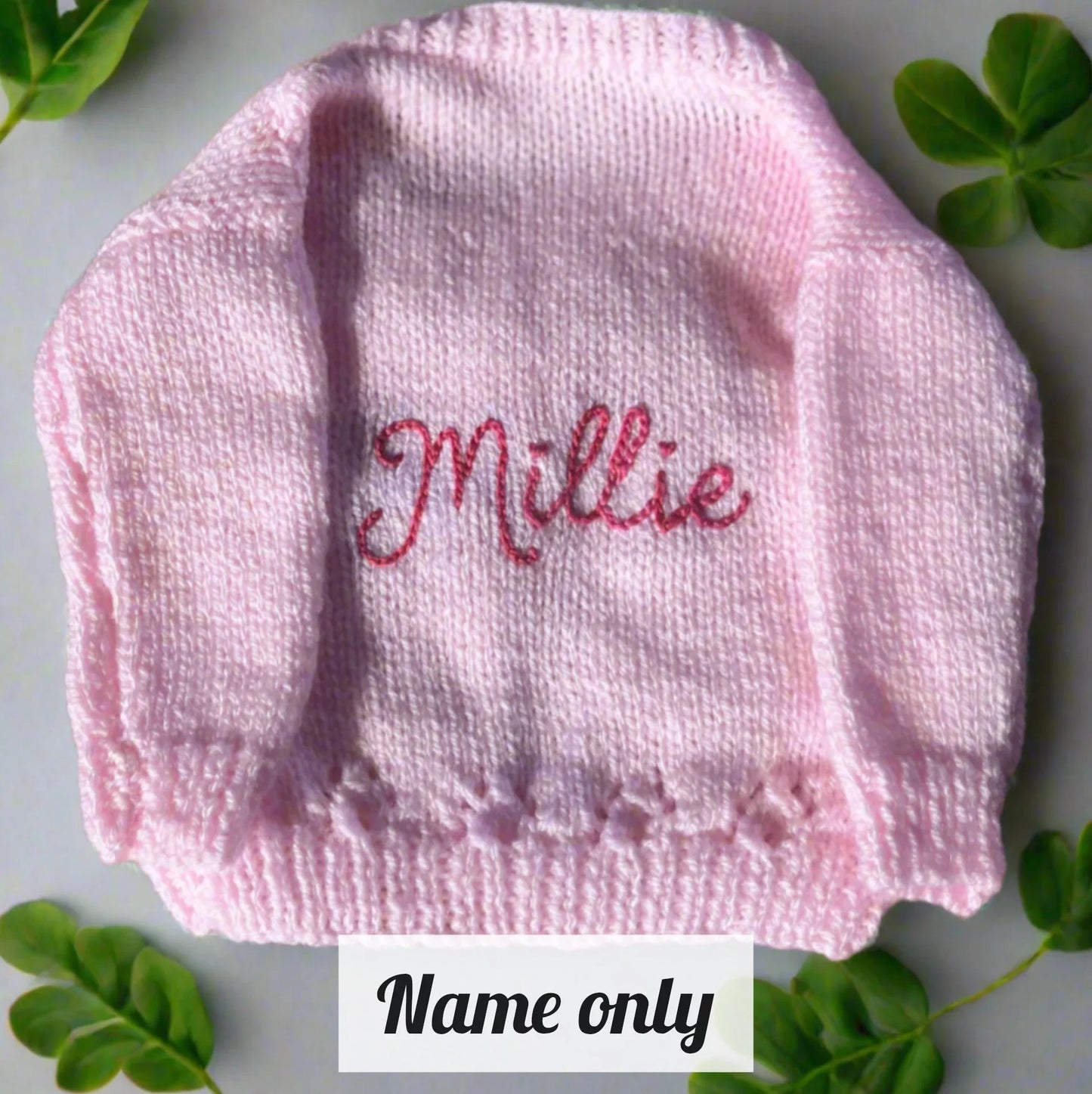 Pink sustainable kids knitwear with flowers personalised with the name Millie by Little Flower Knits