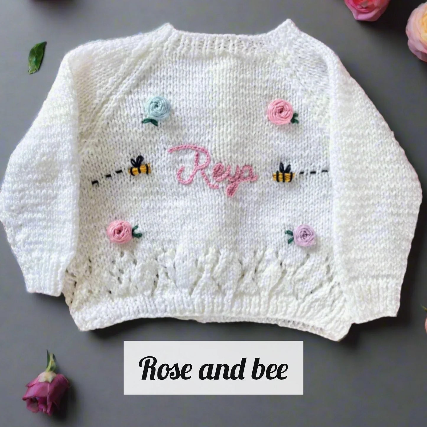 White sustainable kids knitwear with flowers featuring embroidered bees and the name Reva by Little Flower Knits