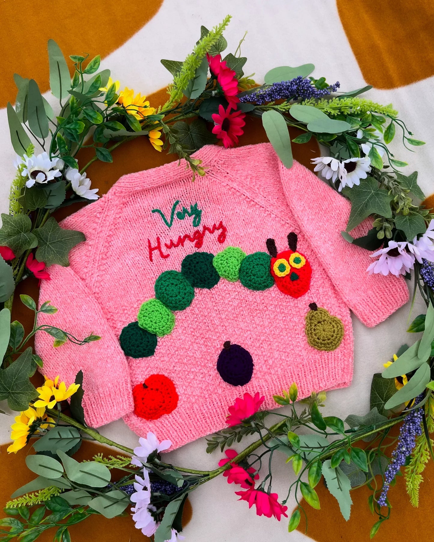 Pink toddler cardigan with unique animal design featuring a green caterpillar and 'Very Hungry' text