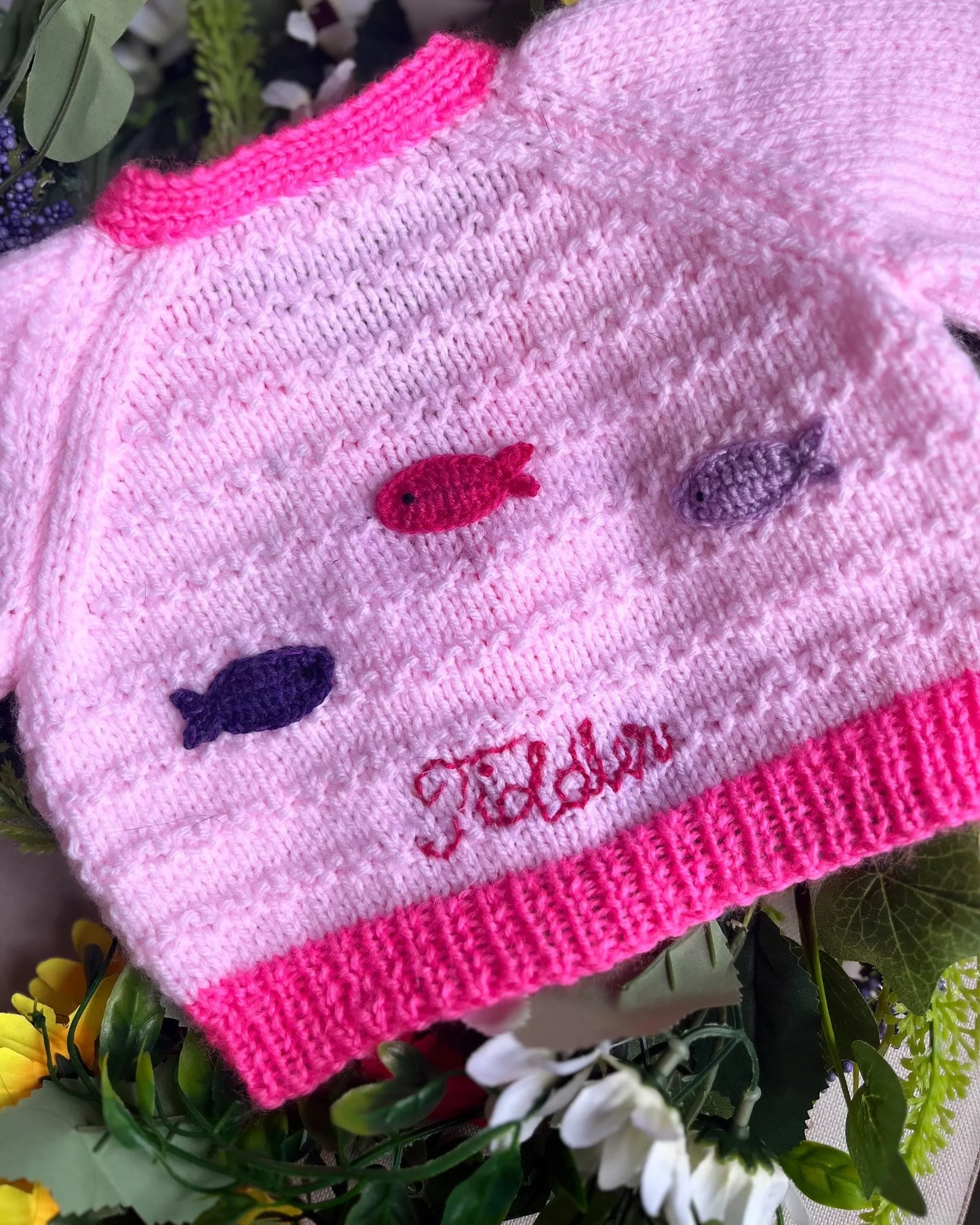 Pink knitted unique baby fish cardigan with colourful fish buttons and embroidered initials by Little Flower Knits