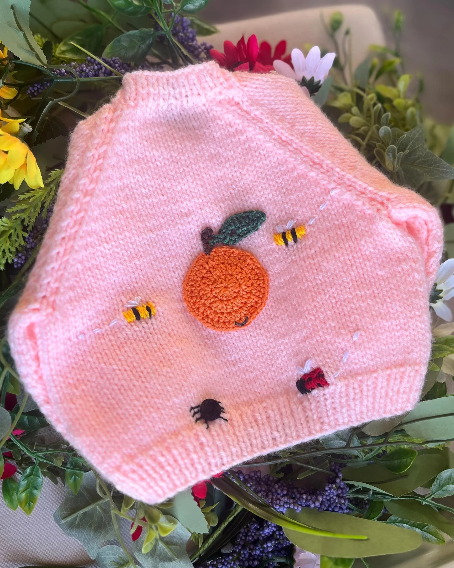 Little Flower Knits pink knitted baby garment with orange and insect buttons unique baby shower gift knitted