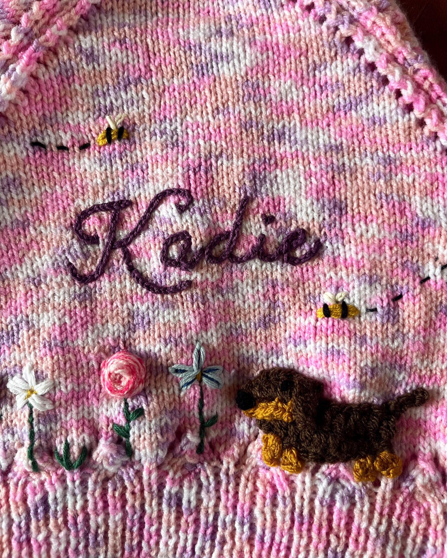 Little Flower Knits unique floral cardigan for girls in pink with embroidered name and knitted dog and flowers