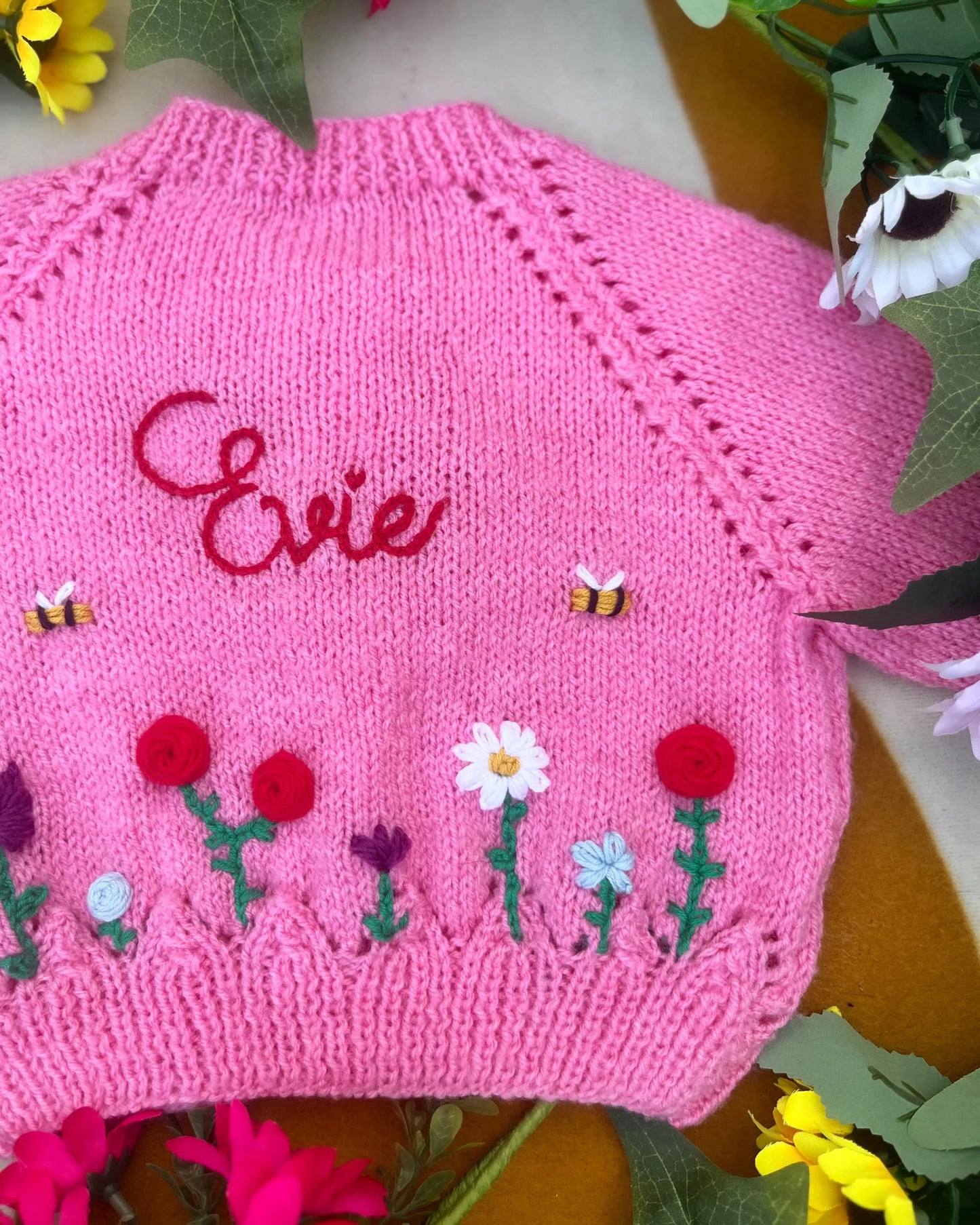Unique floral cardigan for girls in pink knit with embroidered name Evie and flower and bee decorations
