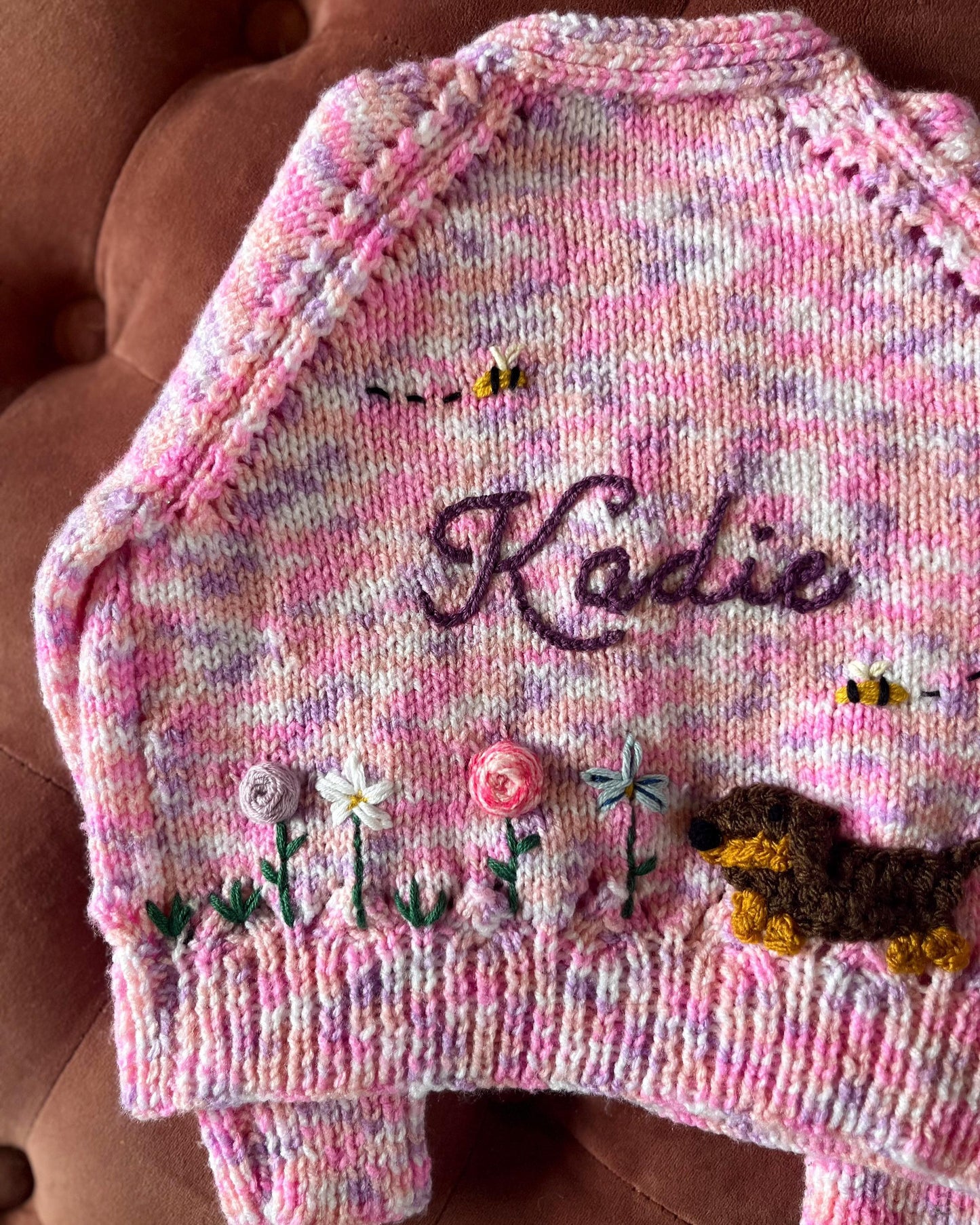 Little Flower Knits unique floral cardigan for girls in pink with knitted flowers, bees, and dog design