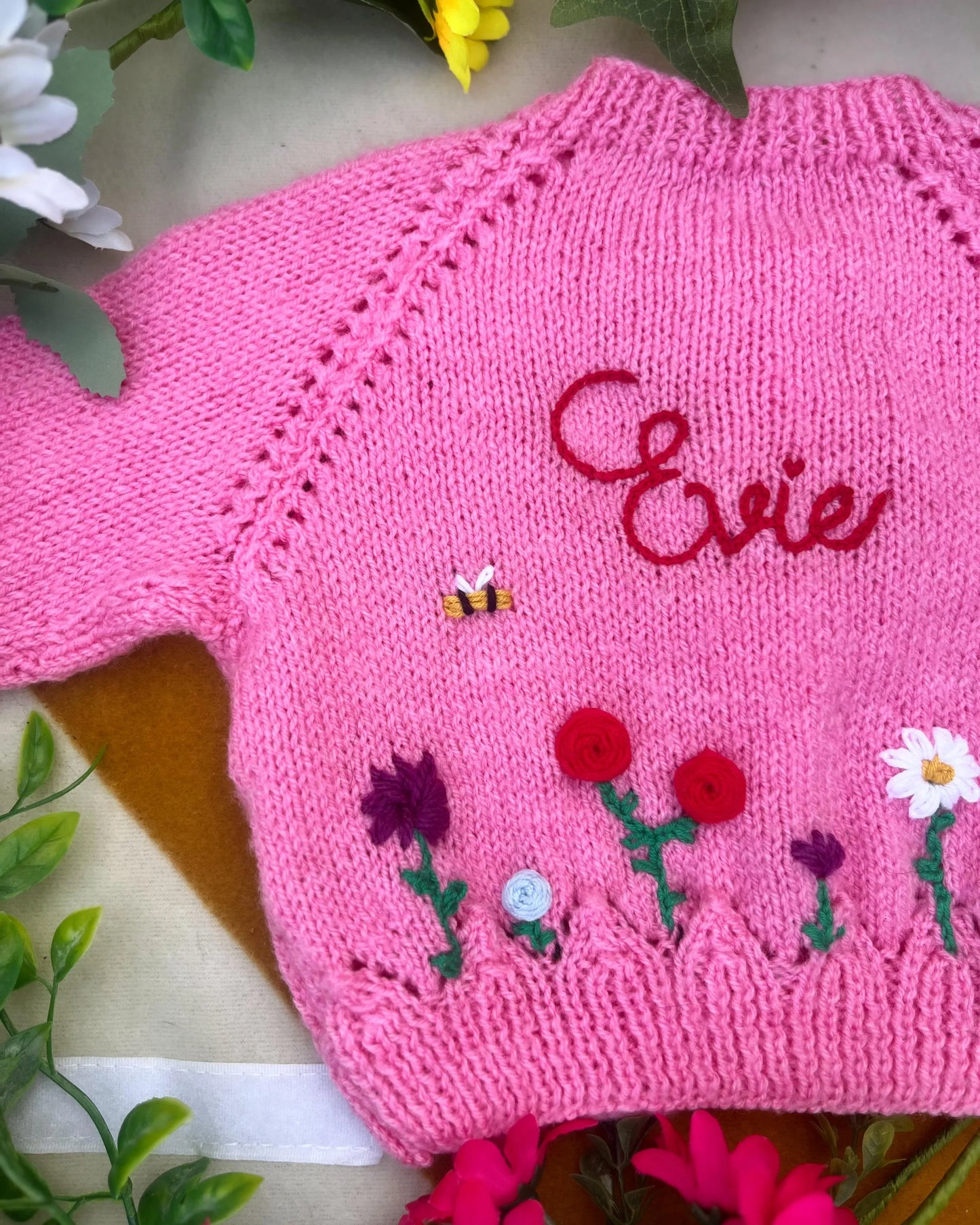 Pink unique floral cardigan for girls with embroidered flowers, bee, and personalised name detail by Little Flower Knits