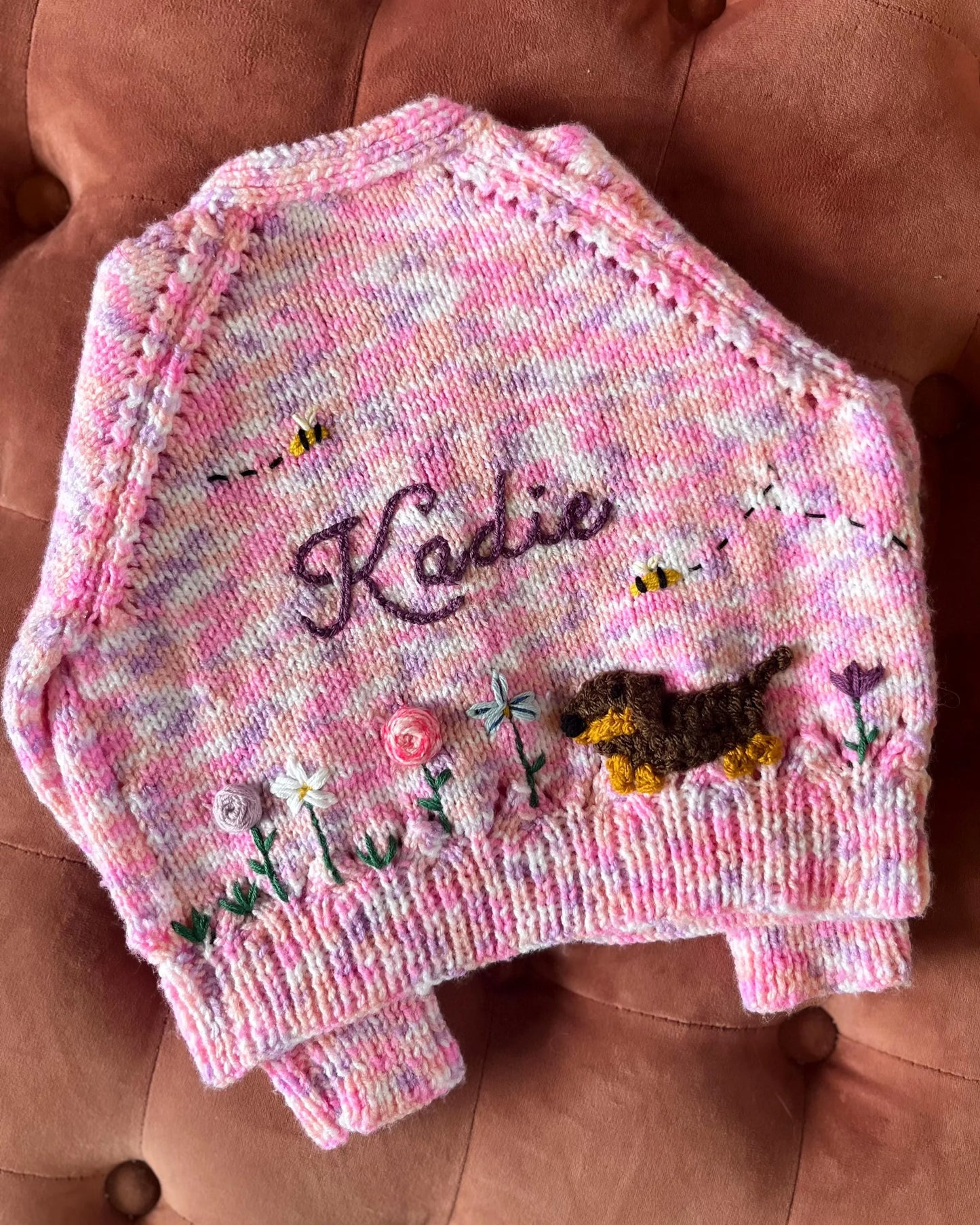 Pink knitted unique floral cardigan for girls with embroidered name Kadie and floral and dog designs