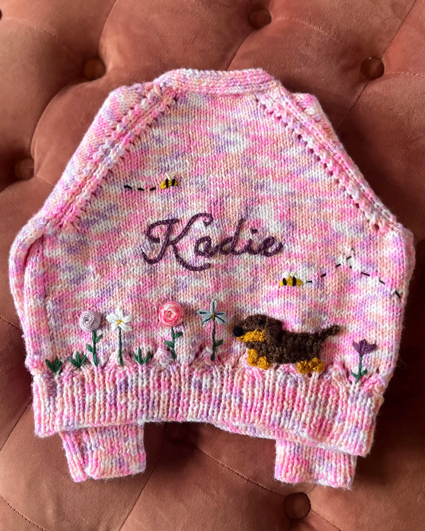Little Flower Knits unique floral cardigan for girls in pink with embroidered flowers and a dog design