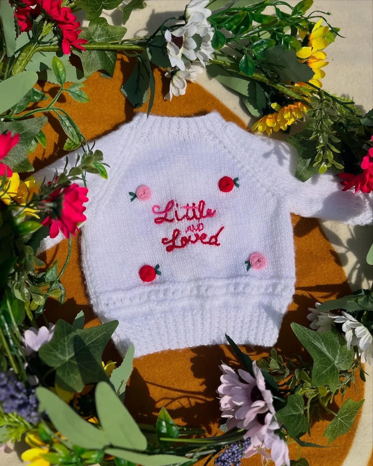 Little Flower Knits white baby jumper with embroidered text surrounded by flowers unique personalised baby gift