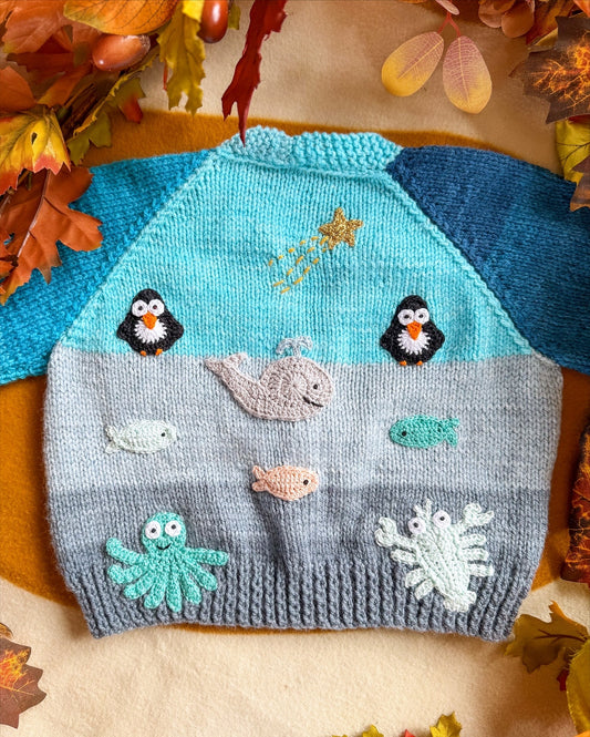Little Flower Knits Arctic animals baby cardigan featuring playful marine critters and colourful design