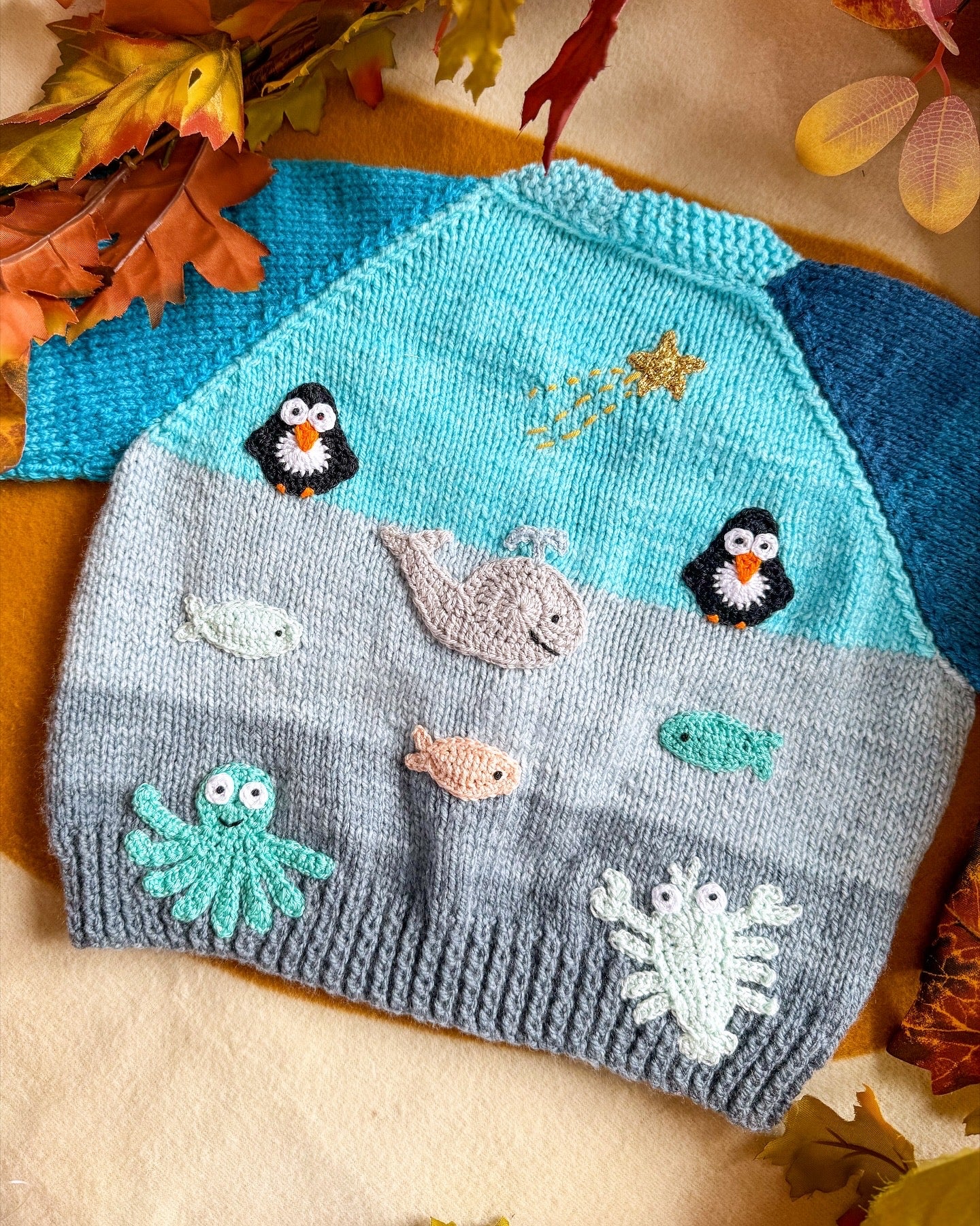 Little Flower Knits Arctic animals baby cardigan with whimsical sea life and penguin designs