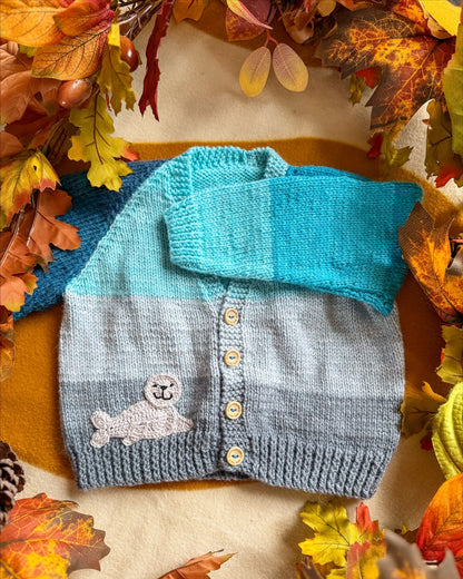 Little Flower Knits Arctic animals baby cardigan in grey and blue with a seal patch and wooden buttons