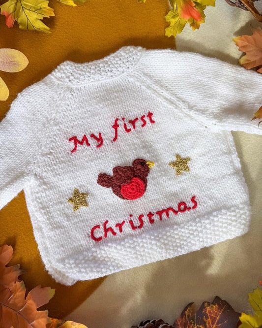 Little Flower Knits baby's first Christmas cardigan in white with festive embroidery and bird design