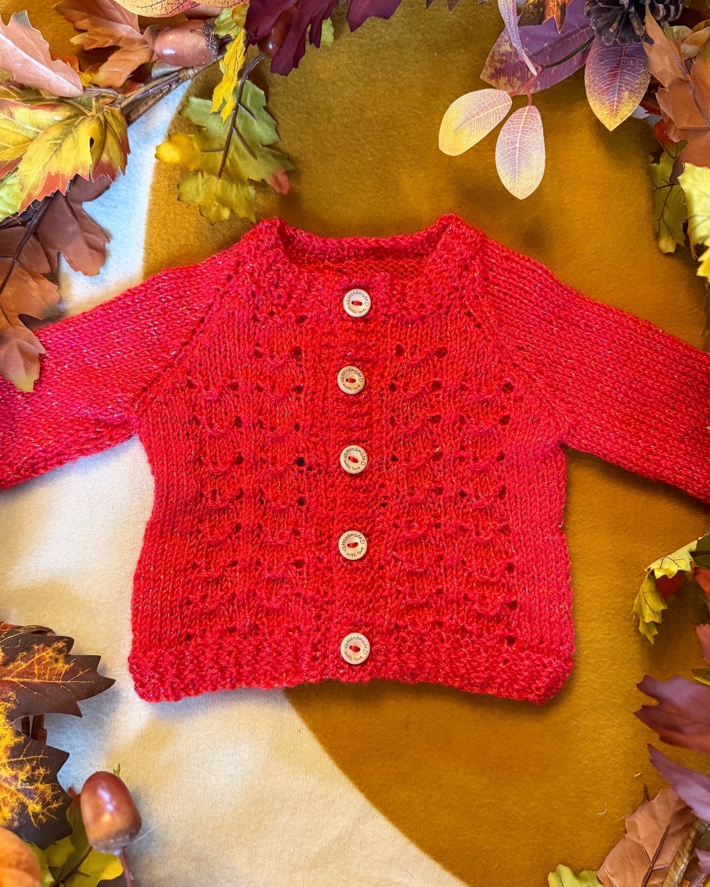 Bright red Christmas baby cardigan 3-6 months with delicate lace pattern and button closure