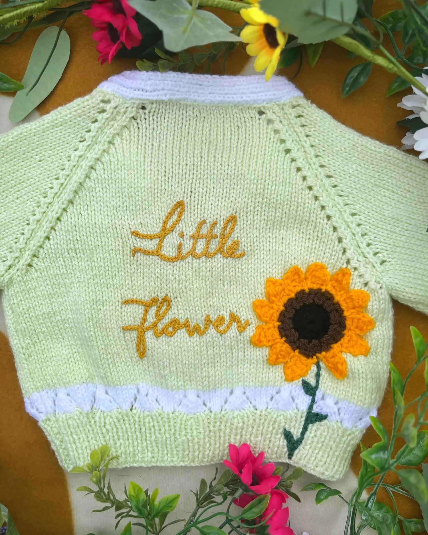 Personalised sunflower cardigan for kids in light green with yellow flower and name embroidery by Little Flower Knits