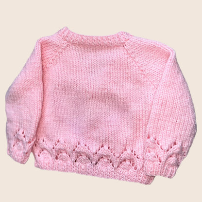 Soft pink knitted baby cardigan with decorative stitch pattern on cuffs and hem design a unique cardigan on our Knit Builder