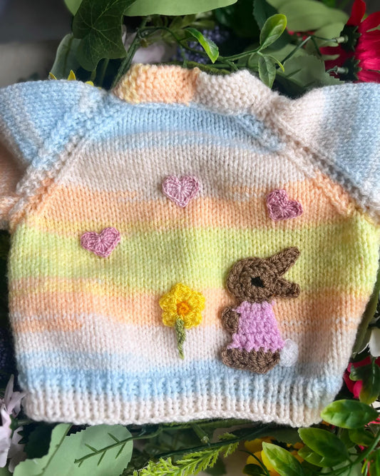 Eco-friendly baby girl cardigan gift with pastel stripes and knitted bunny and heart decorations