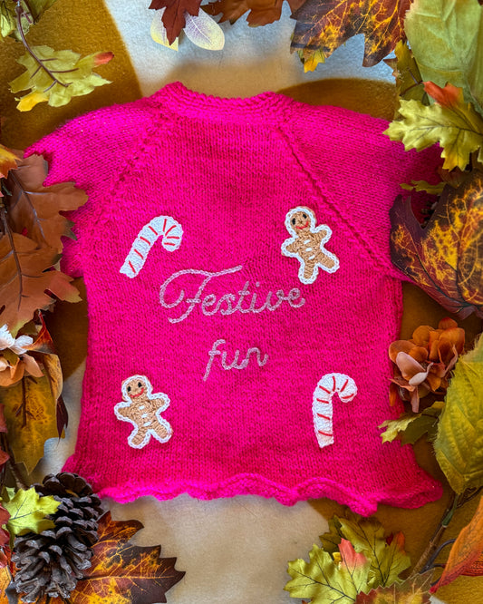 Festive personalised kids cardigan in pink with gingerbread and candy cane embellishments