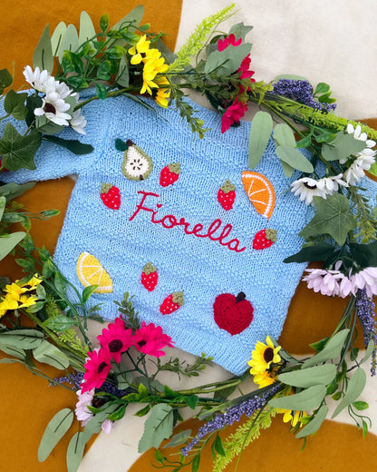 Little Flower Knits blue fruit pattern cardigan for toddlers with embroidered fruit designs and buttons