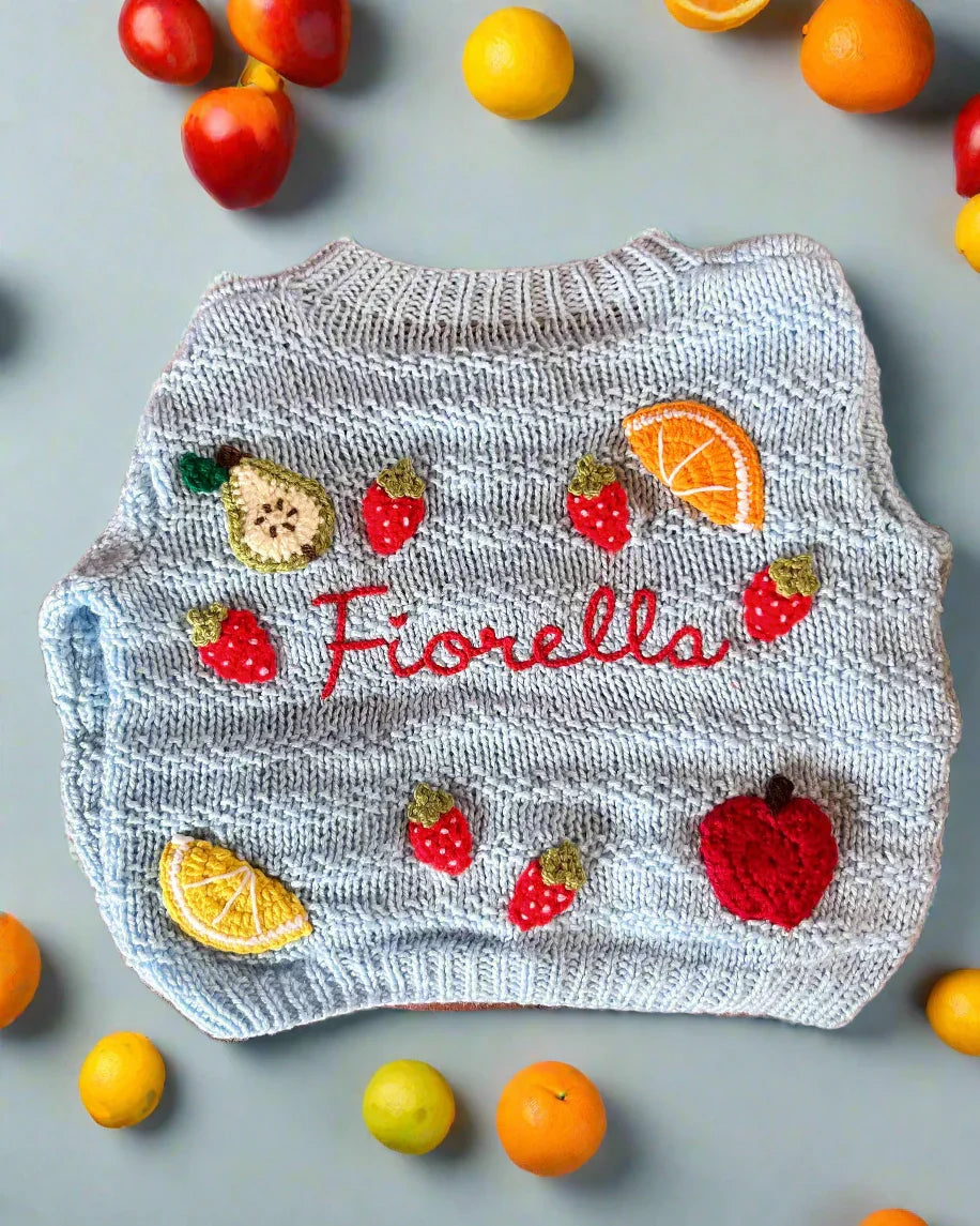 Little Flower Knits blue fruit pattern cardigan for toddlers with embroidered strawberries apple and orange slices