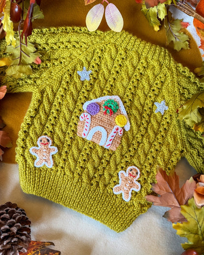Gingerbread cottage baby cardigan in green with decorative gingerbread house and gingerbread men