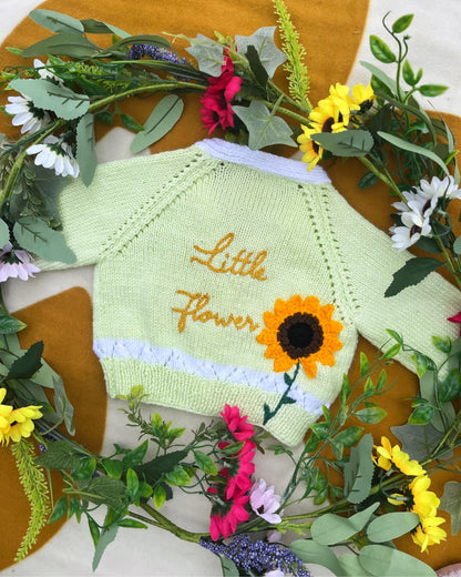 Personalised sunflower cardigan for kids by Little Flower Knits in pastel green with sunflower design and embroidered text