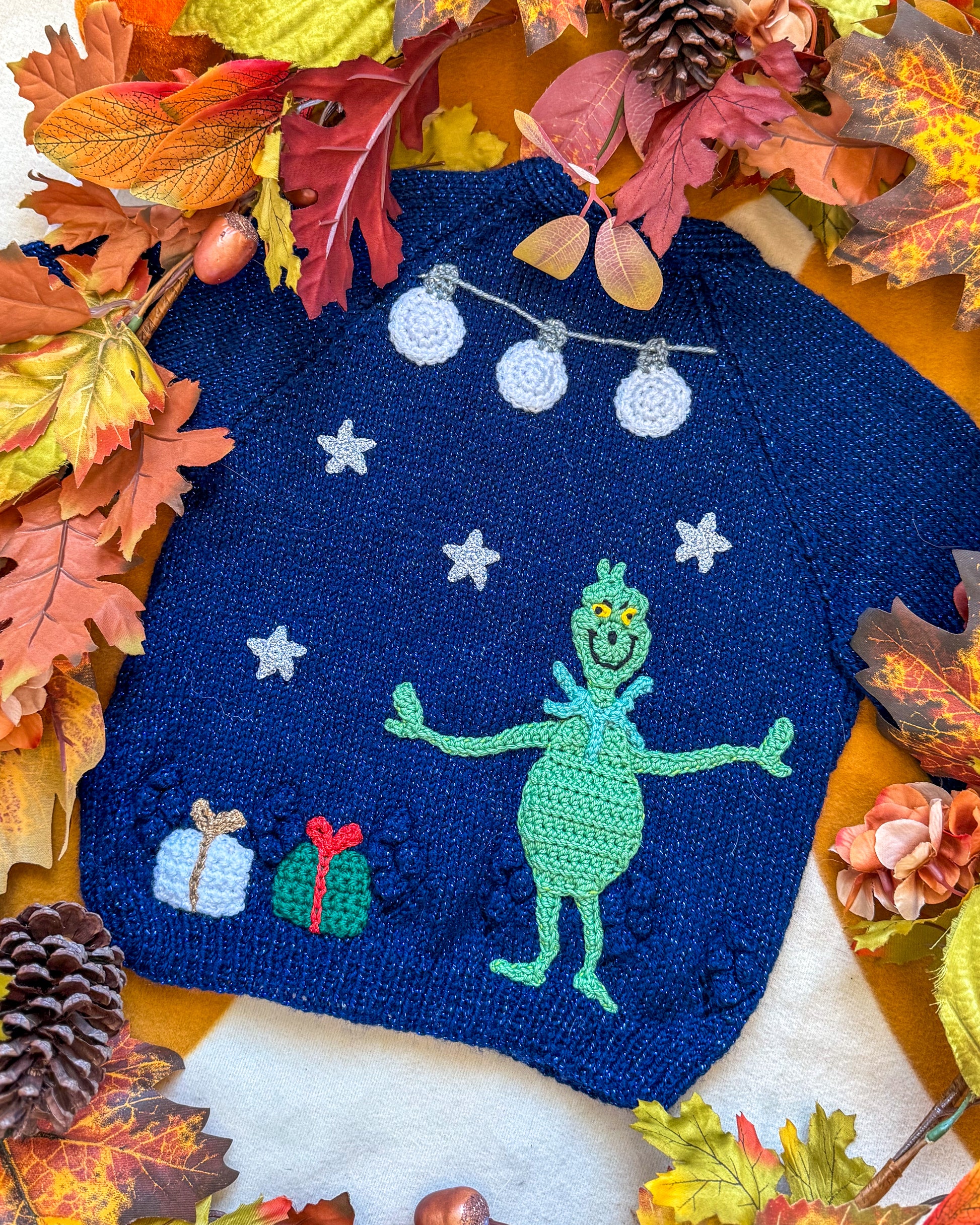Handmade Grinchmas cardigan for toddlers featuring a green Grinch design and festive decorations