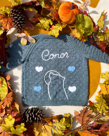 Handknit teal baby cardigan embroidered Conor with wolf outline and hearts autumn setting unique boy wolf gift ideas